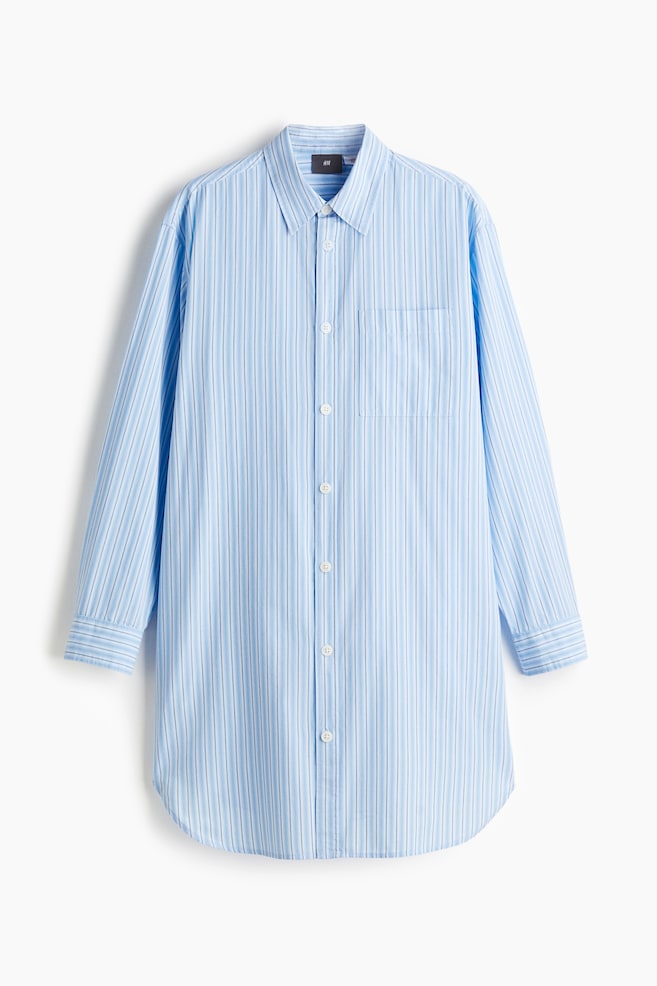 A front-facing long-sleeved shirt is presenting a light blue colour with vertical white and thin darker blue stripes, featuring a pointed collar, a full-length button placket with white buttons, a single chest patch pocket, buttoned cuffs, and a rounded hem. - 1