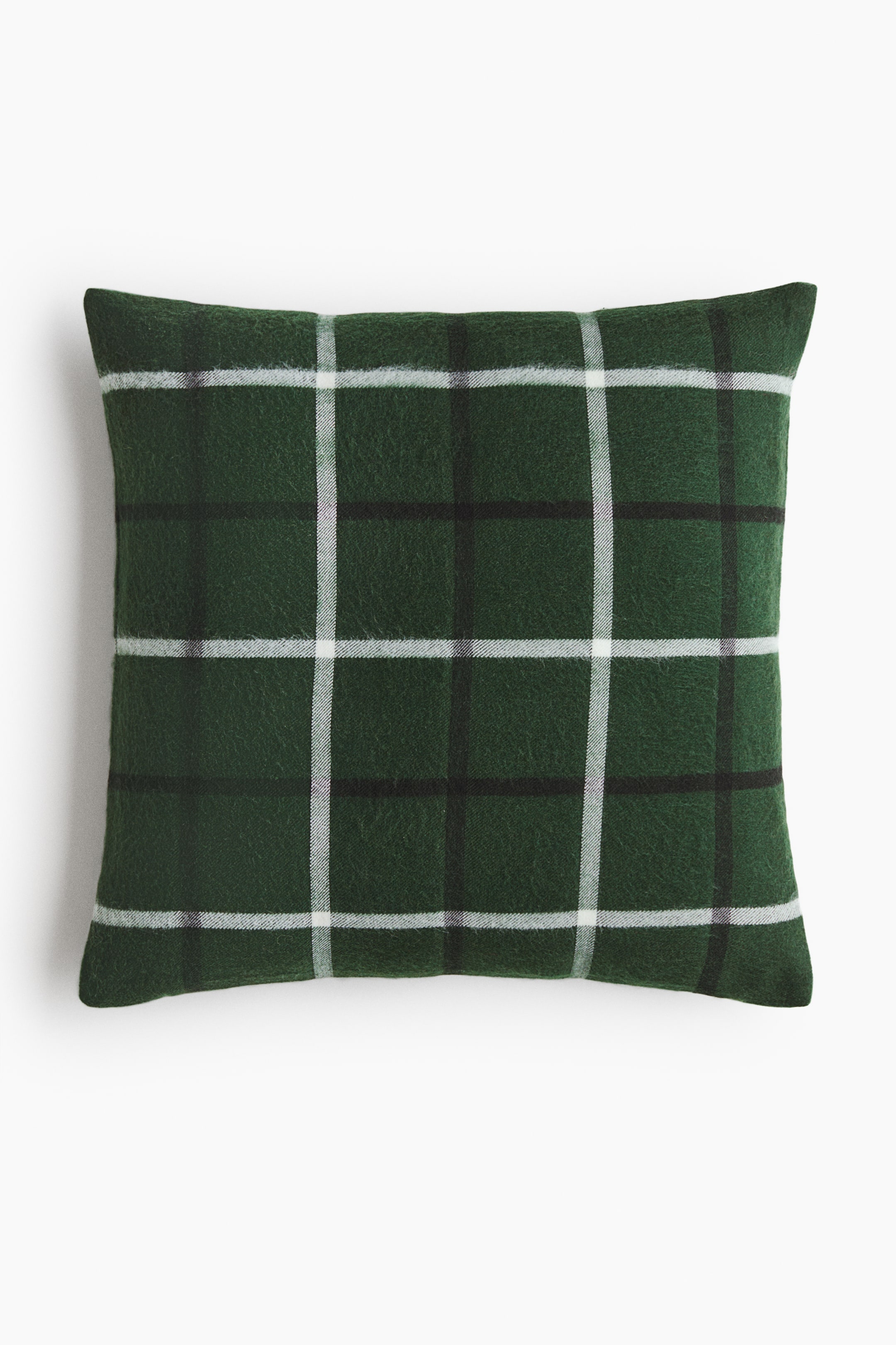 View larger image: A square throw pillow is shown facing front, displaying a dark green, textured fabric with a windowpane plaid pattern of intersecting white and black lines.