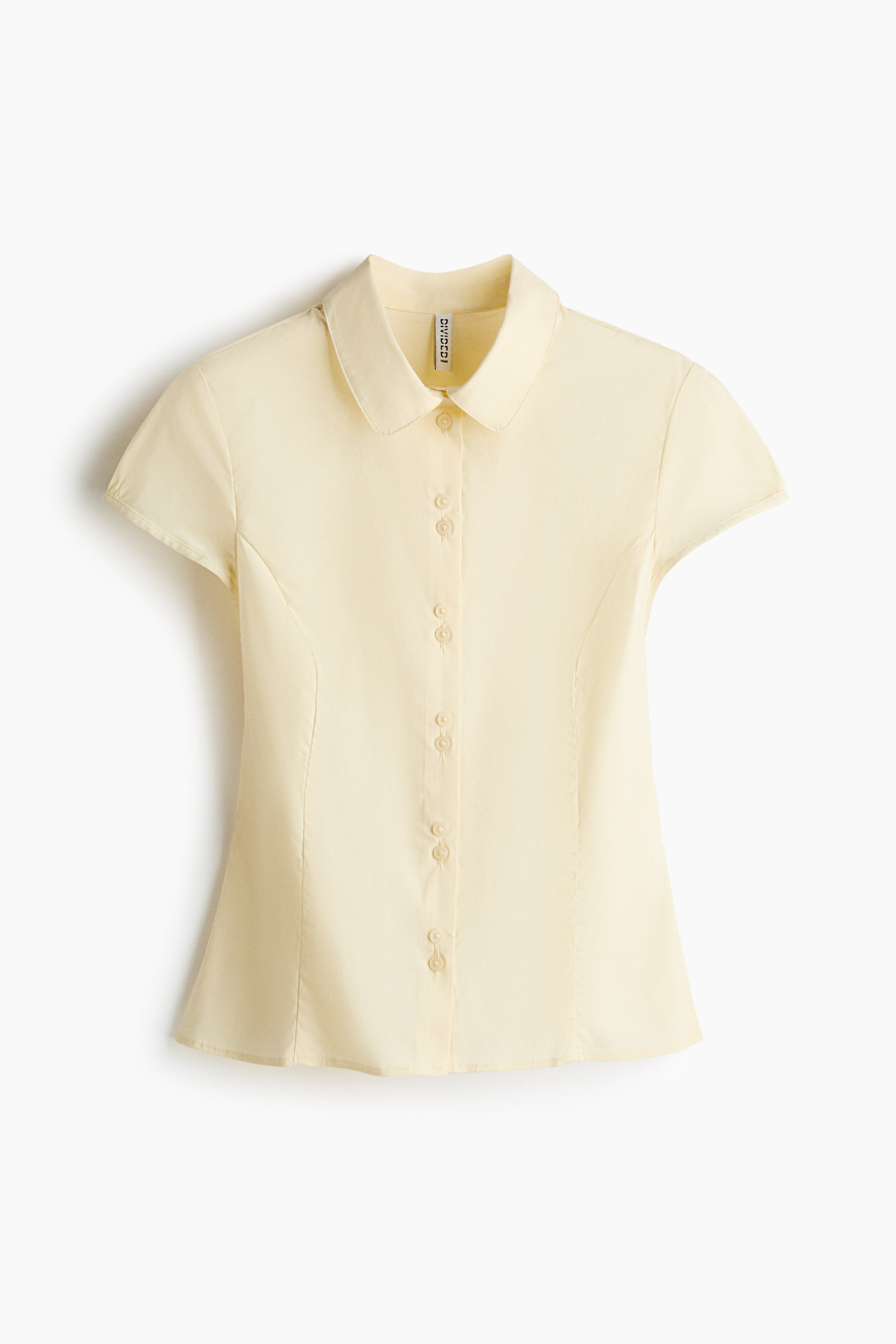 View larger image: A pale yellow short-sleeve shirt, front view, features a classic collar and a full button-front closure with matching buttons. It has fitted short sleeves and visible shaping seams along the sides.