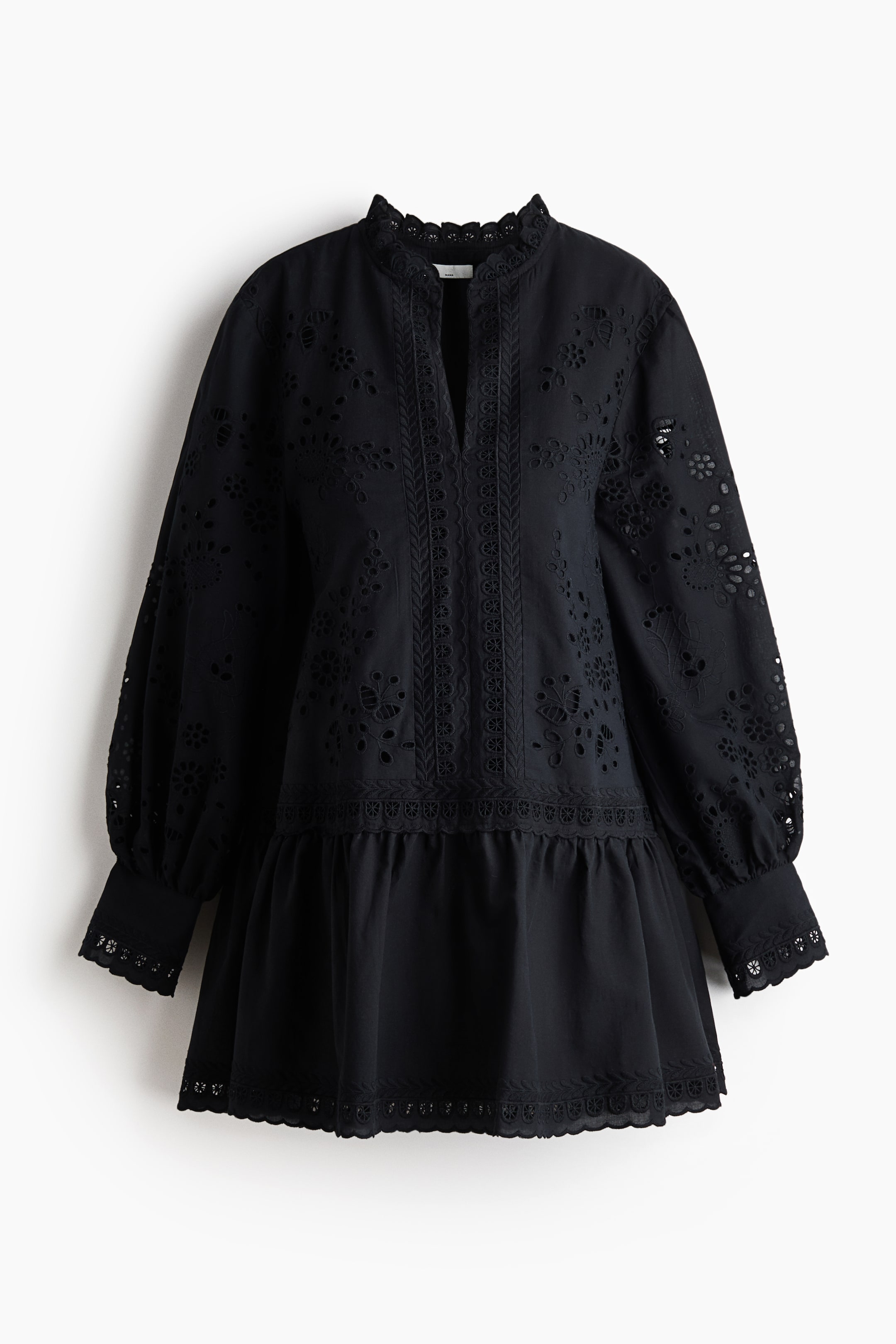 View larger image: A black eyelet embroidered dress is presenting its front, featuring a ruffled stand-up collar and a V-neck opening with vertical lace panels. It is showcasing voluminous long sleeves with scalloped cuffs and a gathered tiered skirt ending in a scalloped hem.