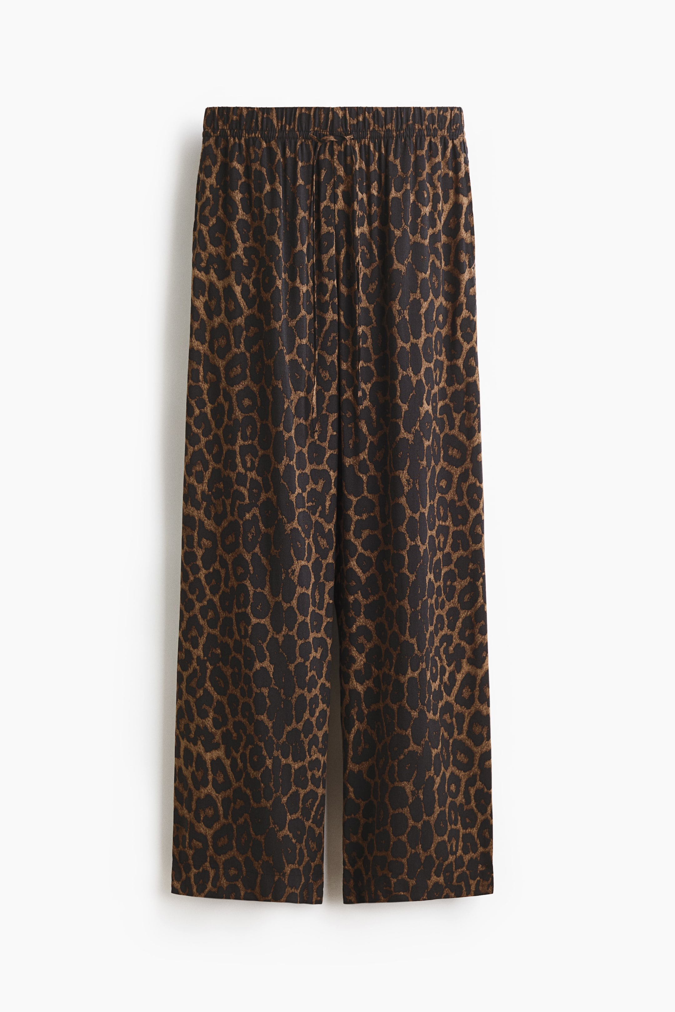 View larger image: The pants showcase a brown and black leopard print, featuring a high elastic waistband with a slim drawstring at the front. They are designed with a relaxed fit and wide, straight legs.