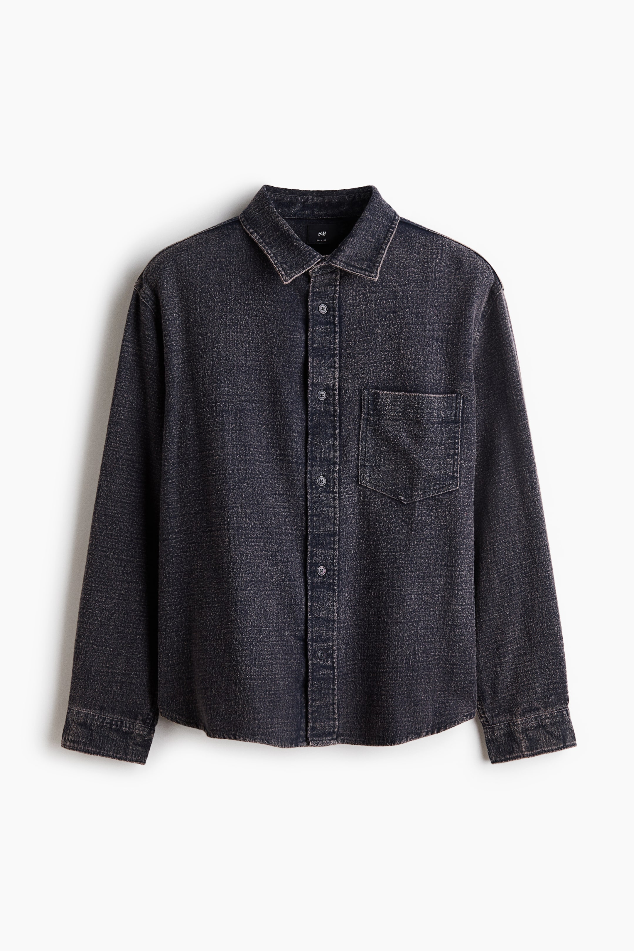 View larger image: A dark grey washed textured shirt is facing front, featuring a pointed collar, a full-button placket, long sleeves with buttoned cuffs, and a single patch pocket on the left chest, all detailed with lighter contrast stitching.