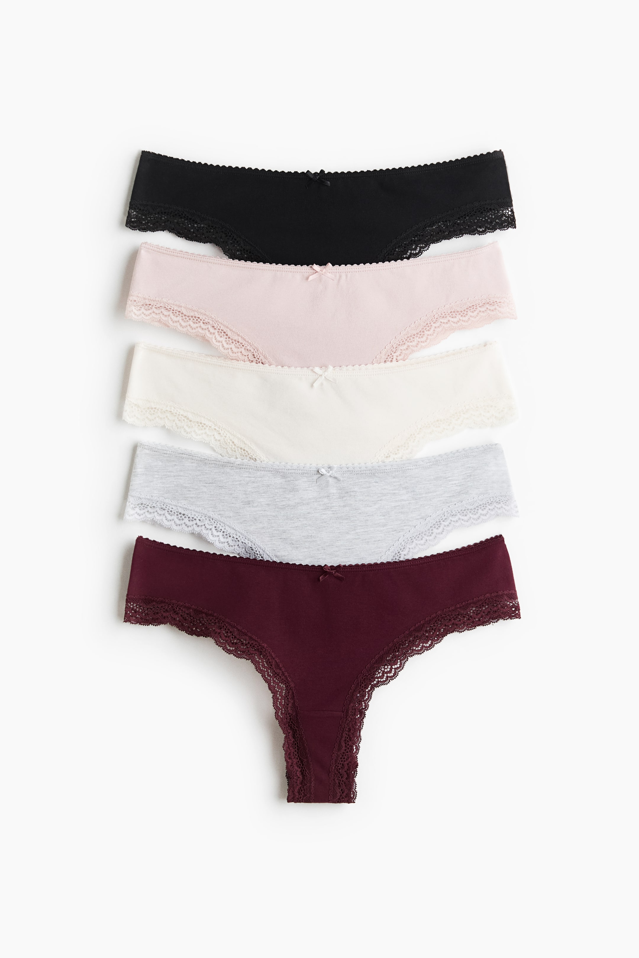 View larger image: Five Brazilian briefs are showcased in a stack, featuring low-waist designs and delicate lace trims along the leg openings and waistline. Each front-facing brief displays a small bow at the centre front, and they appear in black, light pink, off-white, light grey, and burgundy colours.