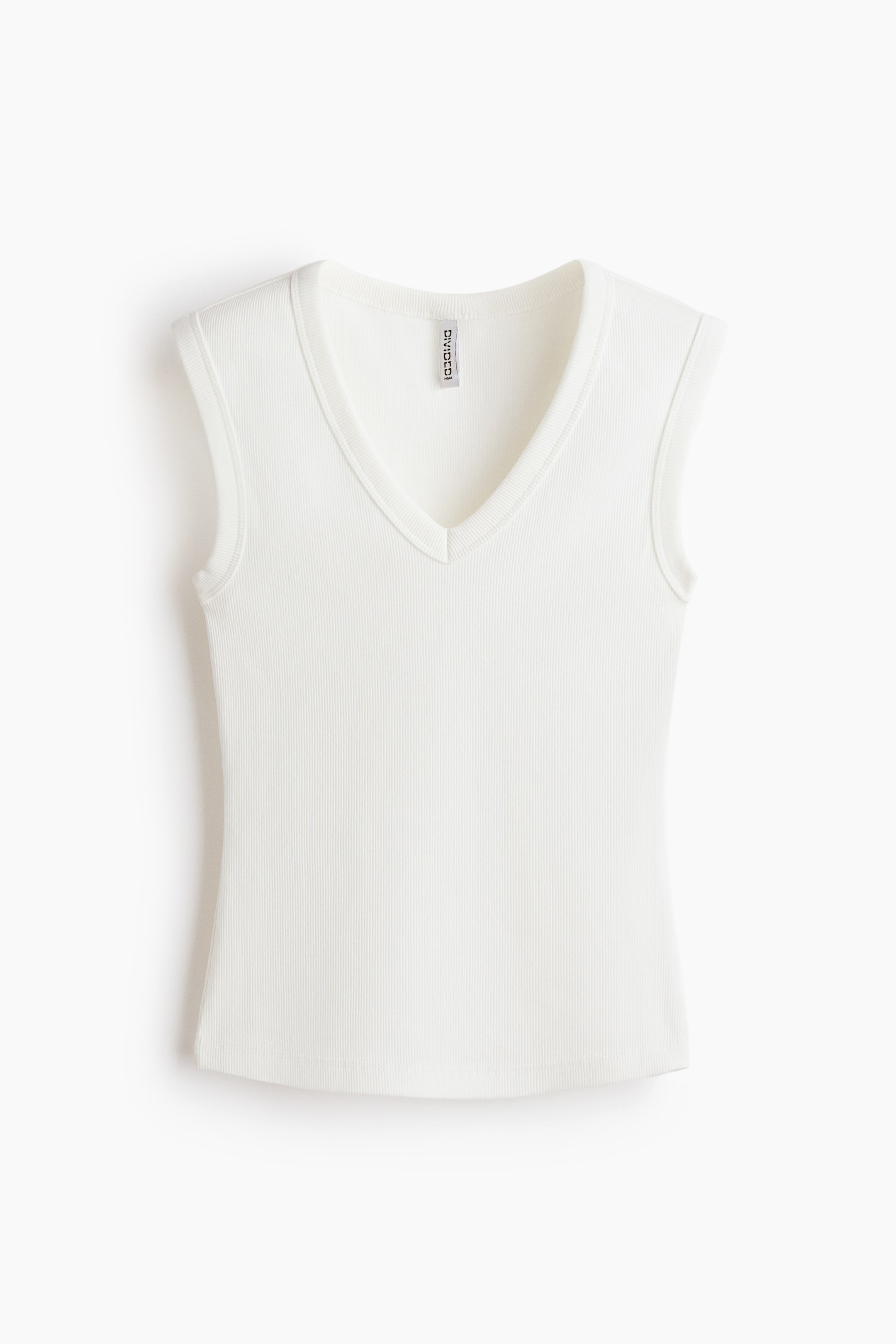 View larger image: A white ribbed knit tank top features a V-neckline, cap sleeves, a slim fit, and a slightly curved hem.