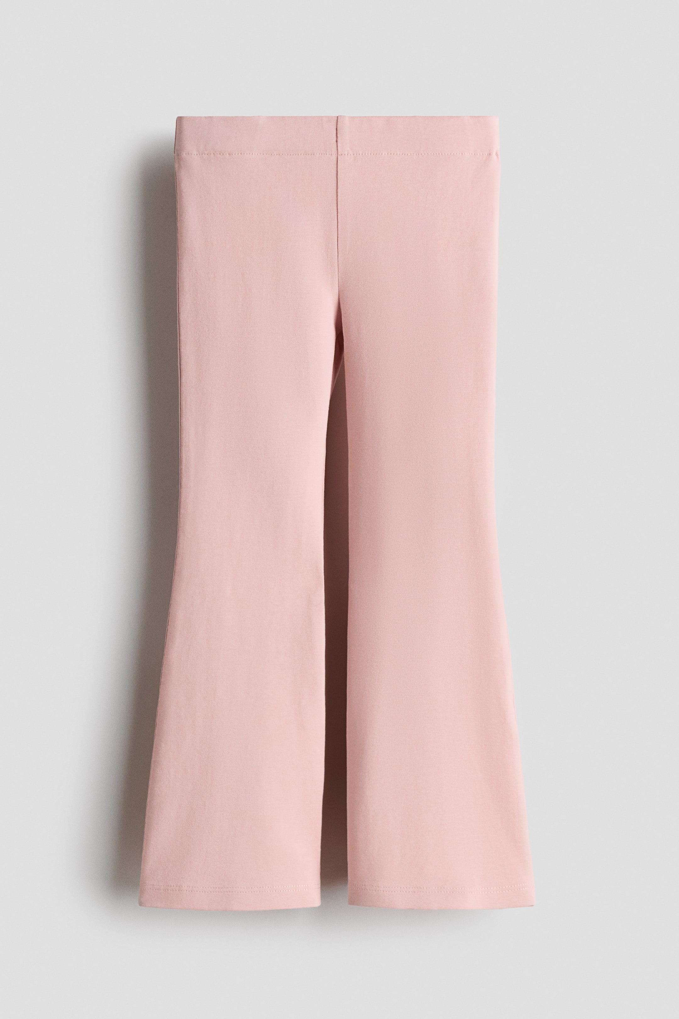 View larger image: Pink leggings feature a smooth texture of soft cotton jersey, an elasticated waist, and flared legs, presented from the front.