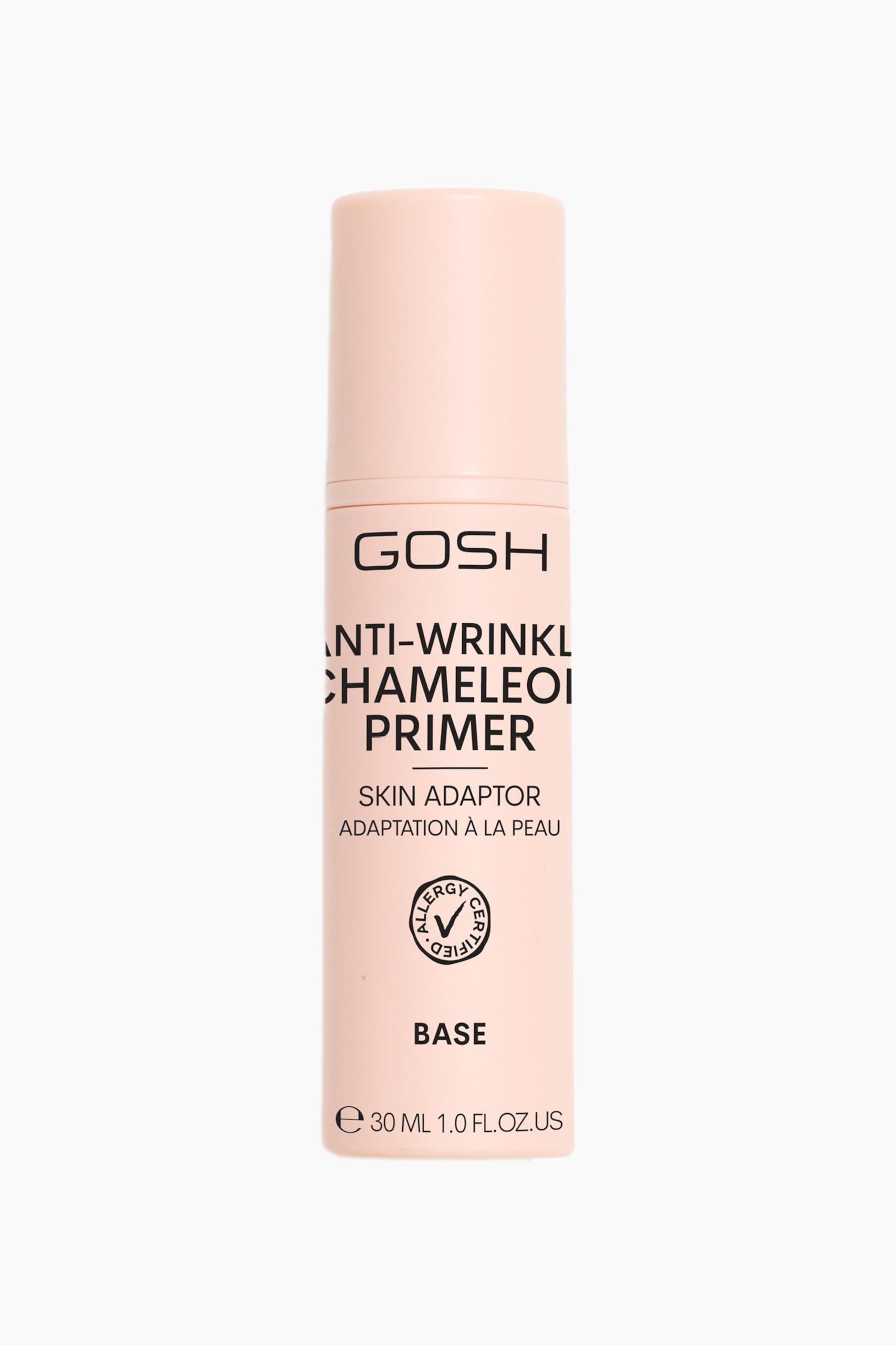 Größeres Bild ansehen: Eine hellrosa zylindrische Flasche mit passendem Deckel steht aufrecht und zeigt nach vorne. Auf der Vorderseite ist schwarzer Text aufgedruckt, darunter 'GOSH ANTI-WRINKLE CHAMELEON PRIMER', 'SKIN ADAPTOR ADAPTATION À LA PEAU', ein 'ALLERGY CERTIFIED' Logo, 'BASE' und 'e 30 ML 1.0 FL.OZ.US'.