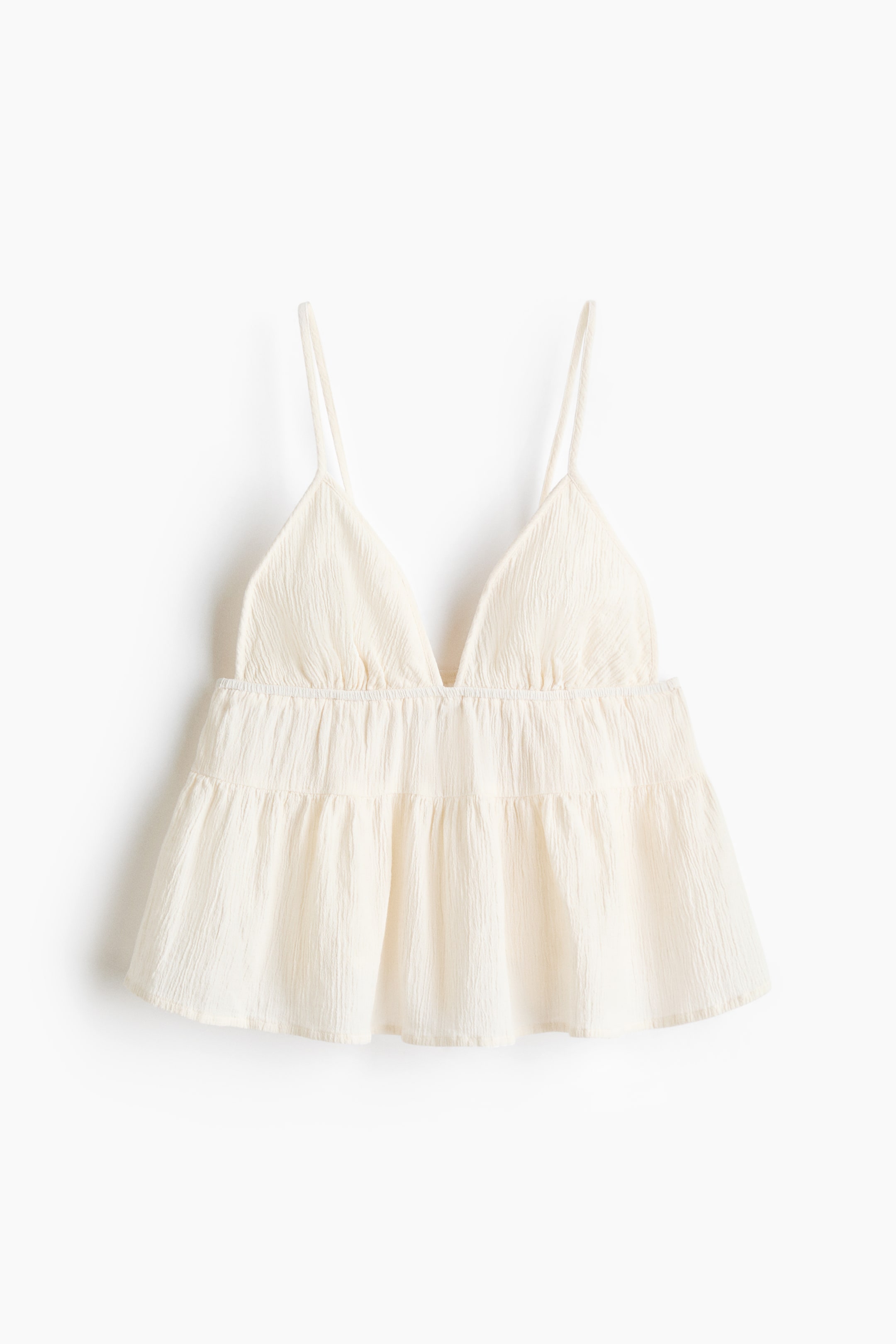 View larger image: Front view of a top, crafted from a crinkled linen blend, showing a V-neckline and narrow, adjustable shoulder straps. It features narrow, gathered elastication under the bust, a gathered seam above the waist, and a gently flared hem.