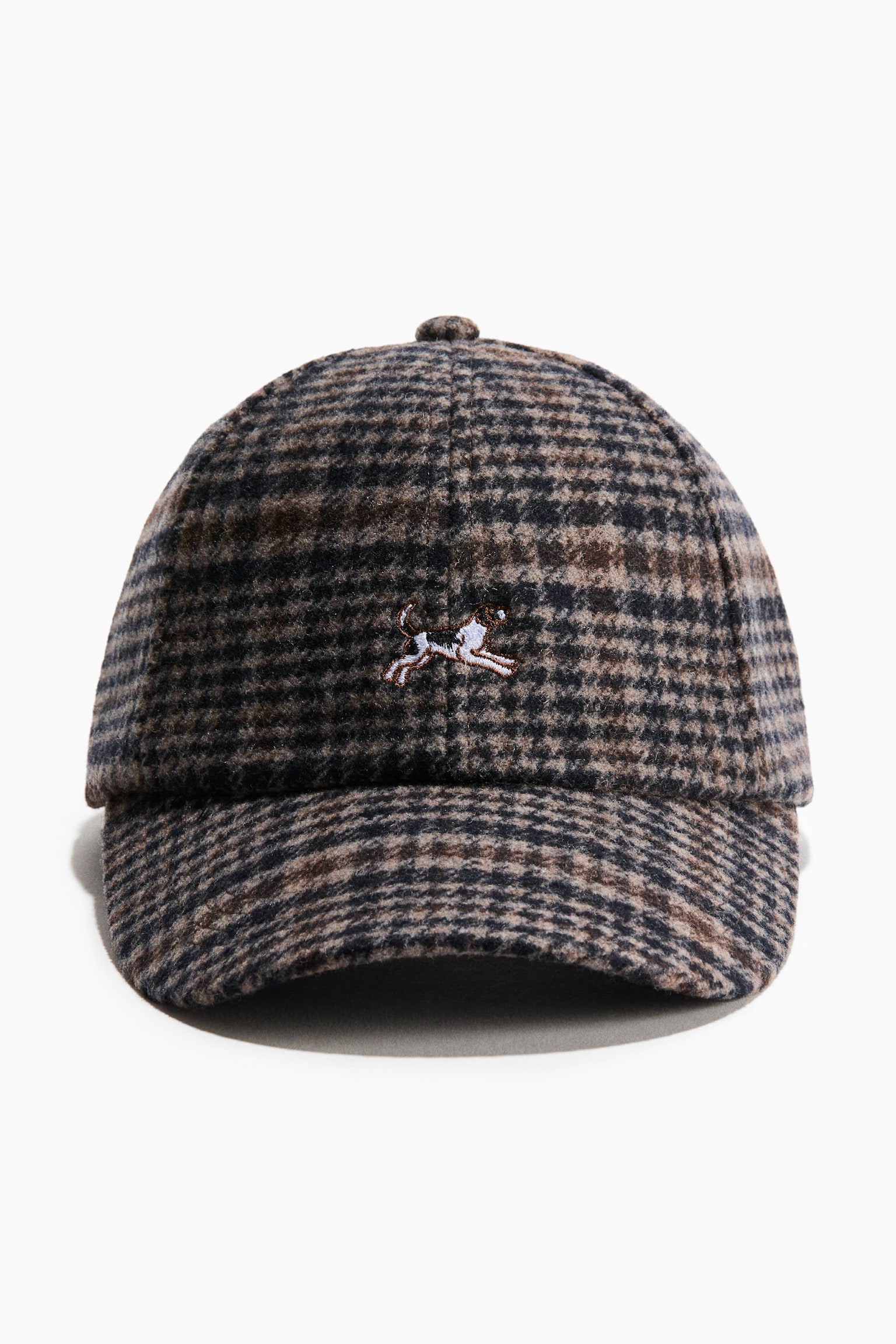 A front-facing view of a wool-blend baseball cap featuring a brown, black and grey patterned plaid with a soft, textured finish. The cap is displaying a small embroidered running dog on the centre front of the crown.