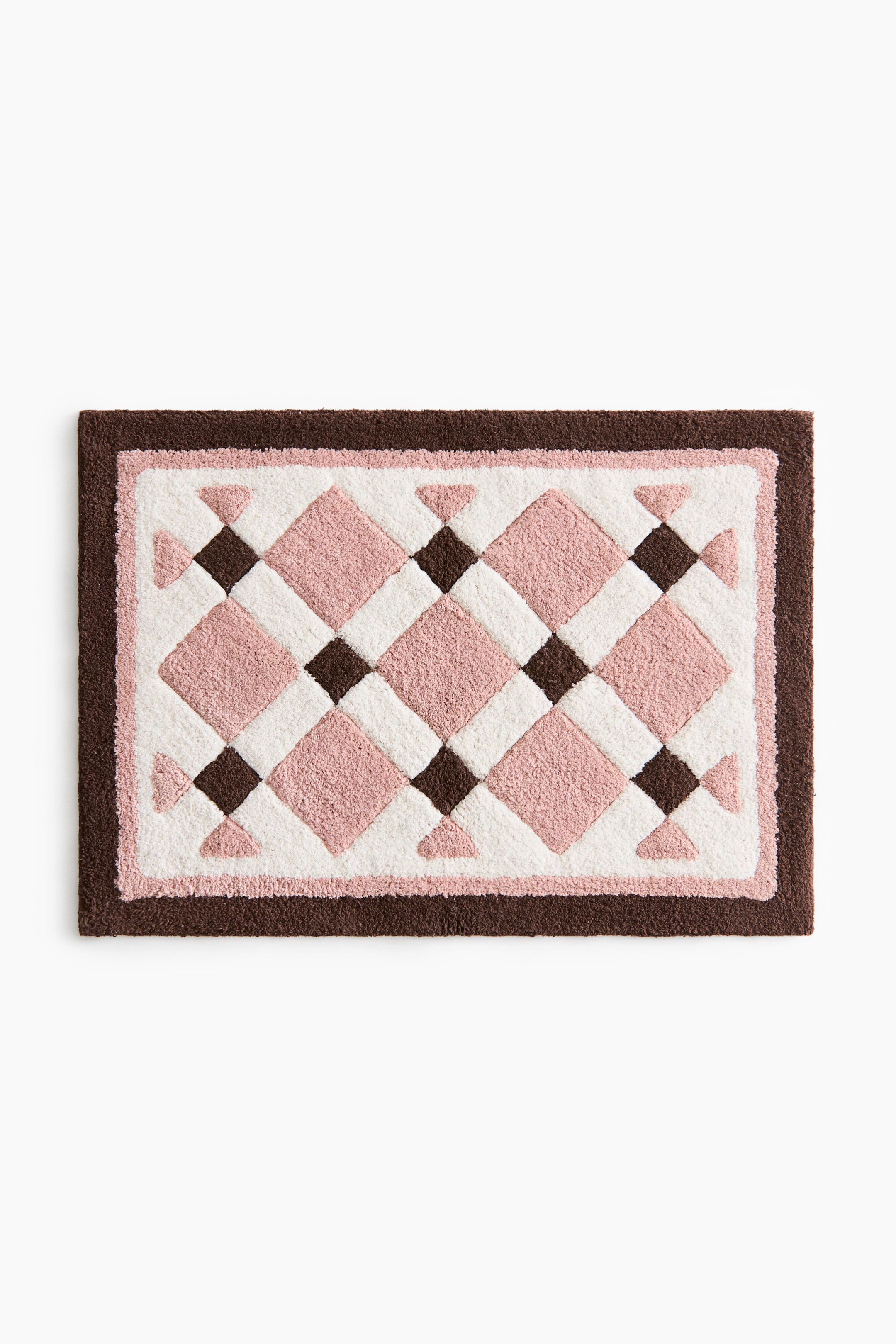 View larger image: The rug is rectangular in shape, showcasing a plush shaggy pile texture with a geometric design. The pattern includes a dark brown outer border, a white inner border, and a central motif of interlocking pink and white diamonds. Small dark brown squares are positioned at the intersections, and pink triangles accentuate the edges.
