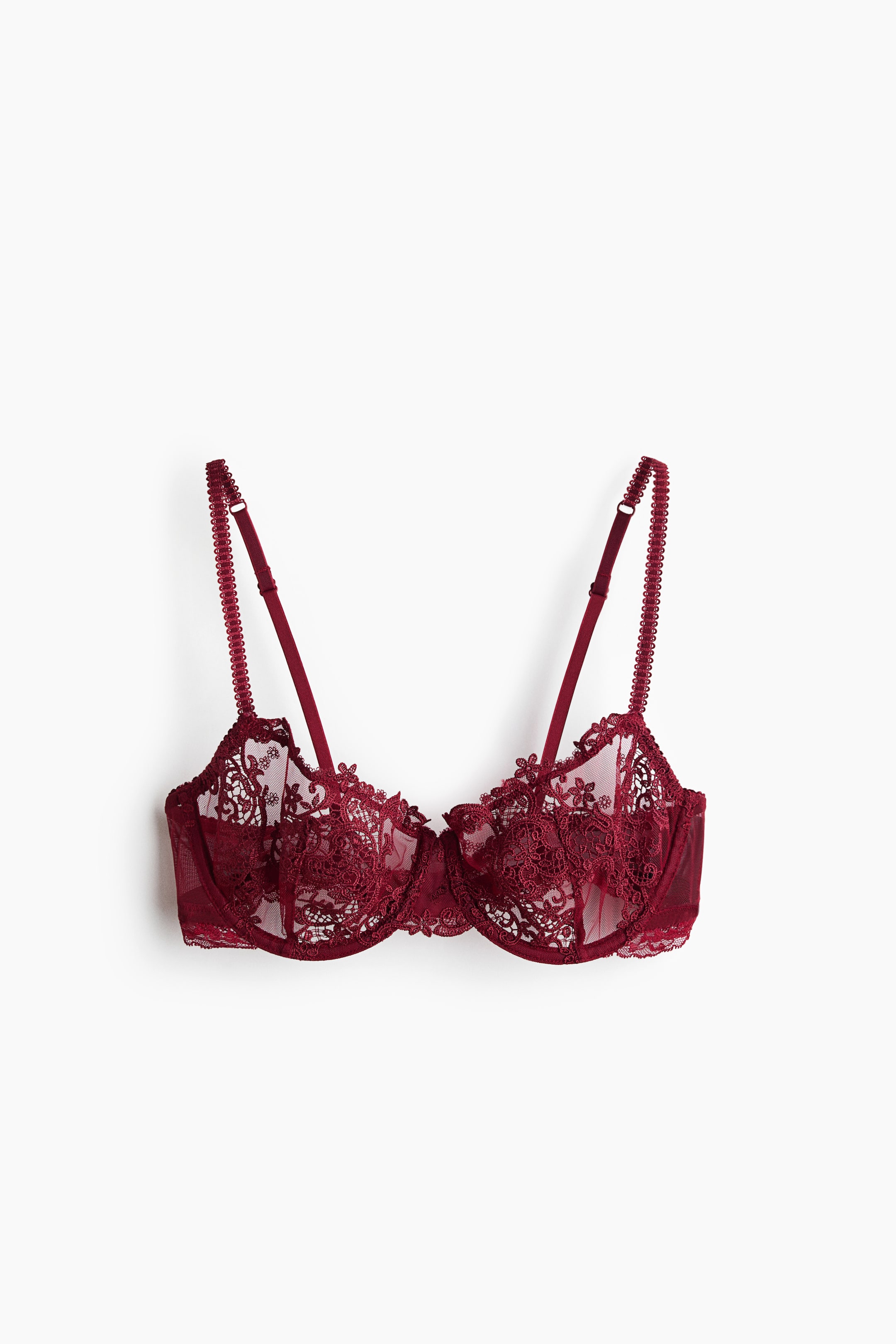 Visualizza immagine più grande: Un reggiseno con ferretto in pizzo bordeaux è mostrato frontalmente, con coppe in rete trasparente non imbottite decorate da ricami floreali intricati e bordi smerlati. Presenta sottili spalline regolabili con rifiniture testurizzate e una fascia sottoseno coordinata in pizzo.