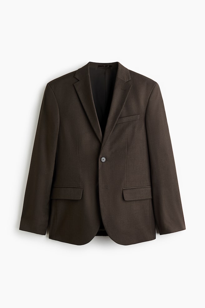 En mÃ¶rkbrun kavaj med enkelknÃ¤ppning Ã¤r vÃ¤nd framÃ¥t och har slag med notch-revers, en brÃ¶stficka med passpoal samt tvÃ¥ nedre fickor med lock. Kavajen har en strukturerad, regular fit-silhuett med en enda knapp knÃ¤ppt framtill. - 1