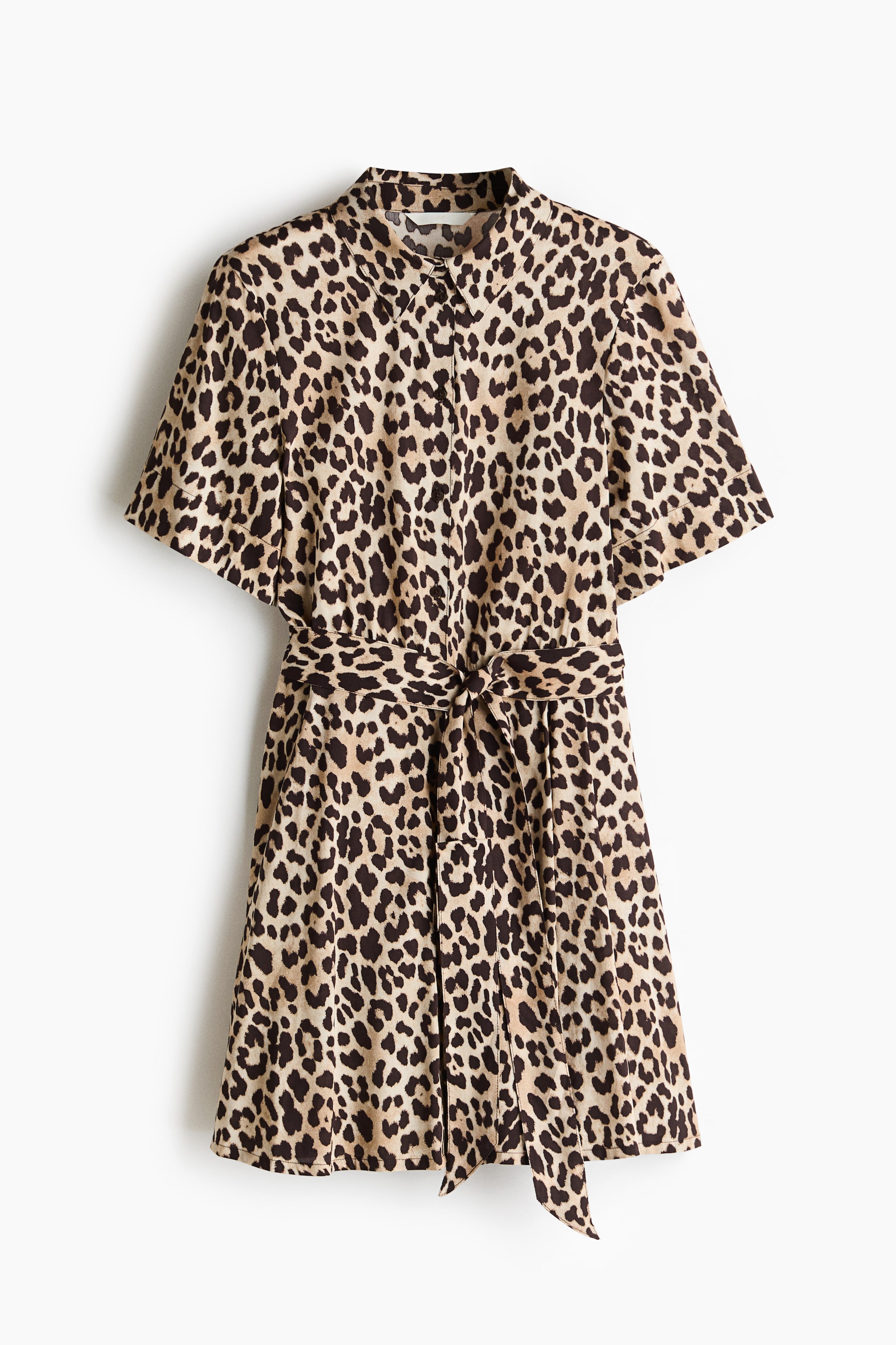 View larger image: A short dress in a leopard print pattern showcases its front, featuring a stand-up collar, metal buttons down the front of its fitted bodice, short sleeves, and a detachable tie belt cinching the waist and forming a bow above a circular skirt.