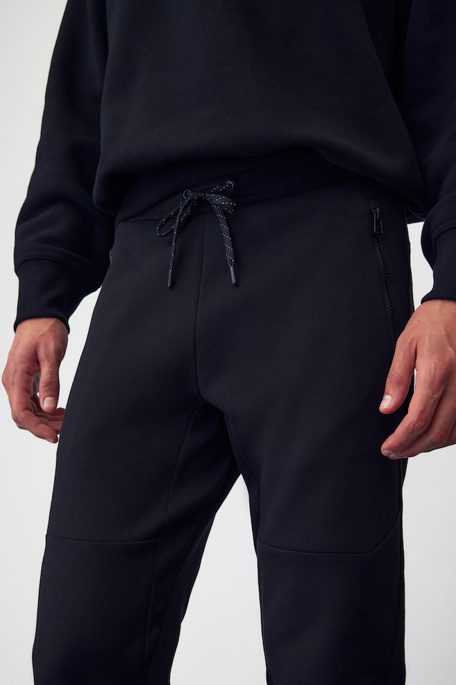 DryMove™ Tapered tech joggers with zipped pockets - Black/Light grey marl/Dark red/Block-coloured/Black/dc - 6