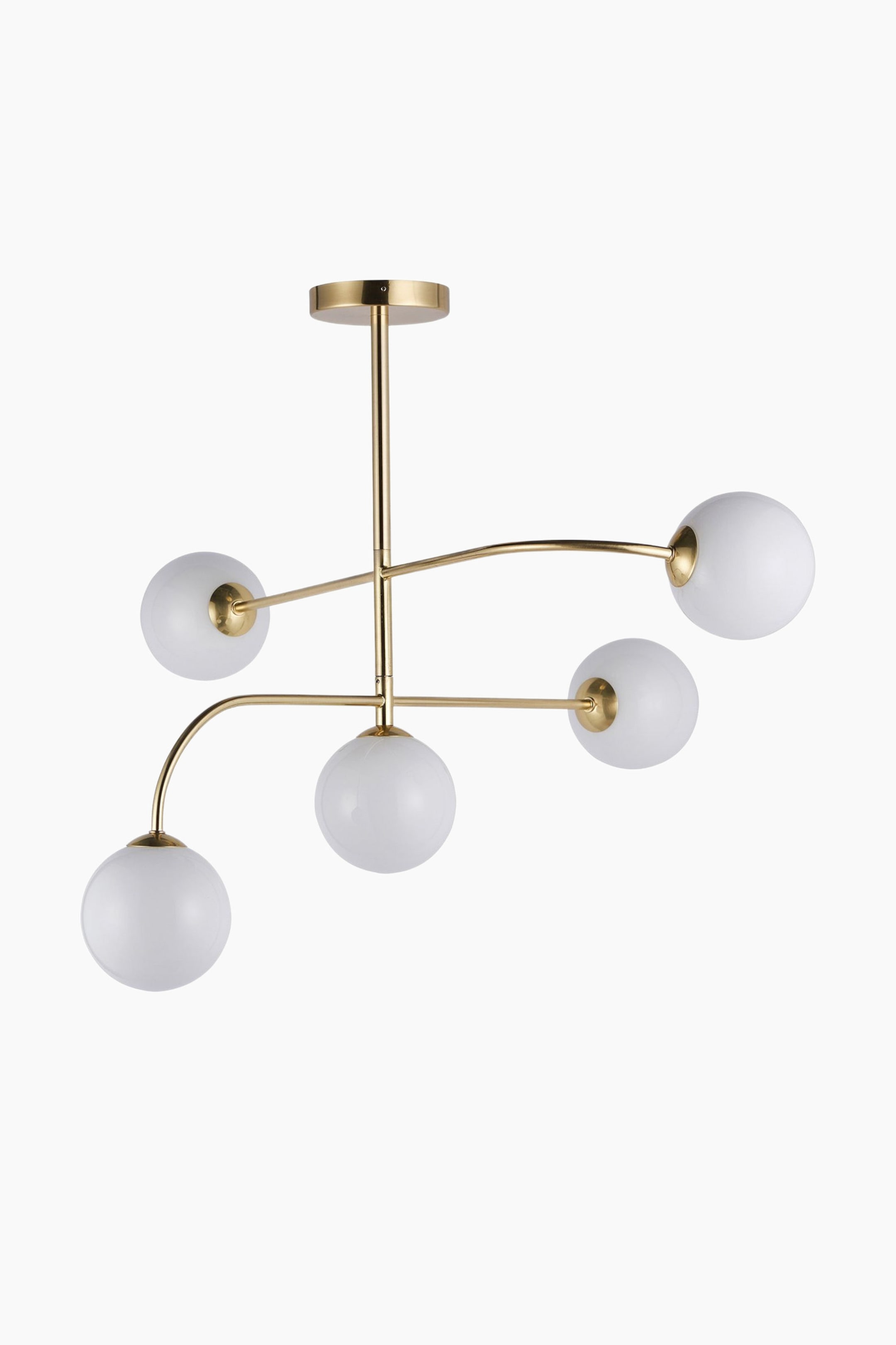 View larger image: A gold-toned chandelier features a circular ceiling mount and a central rod. Five milky white spherical glass globes extend from the rod on curved and straight gold-toned arms, forming an asymmetrical design.