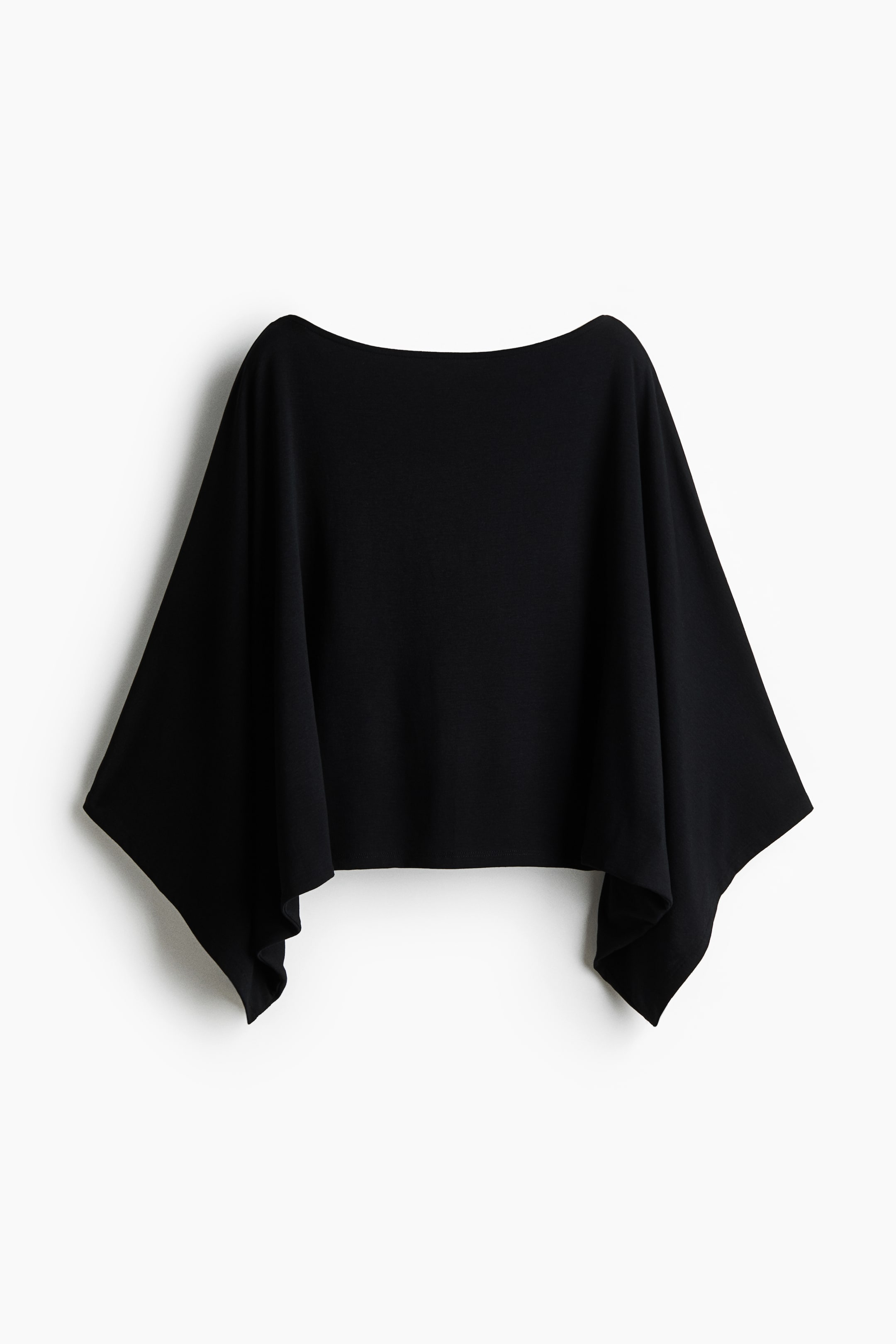 View larger image: A black flowing top showcases its FRONT, highlighting a wide boat neckline and integrated, wide sleeves that form a draped, angular silhouette with pointed side hems.