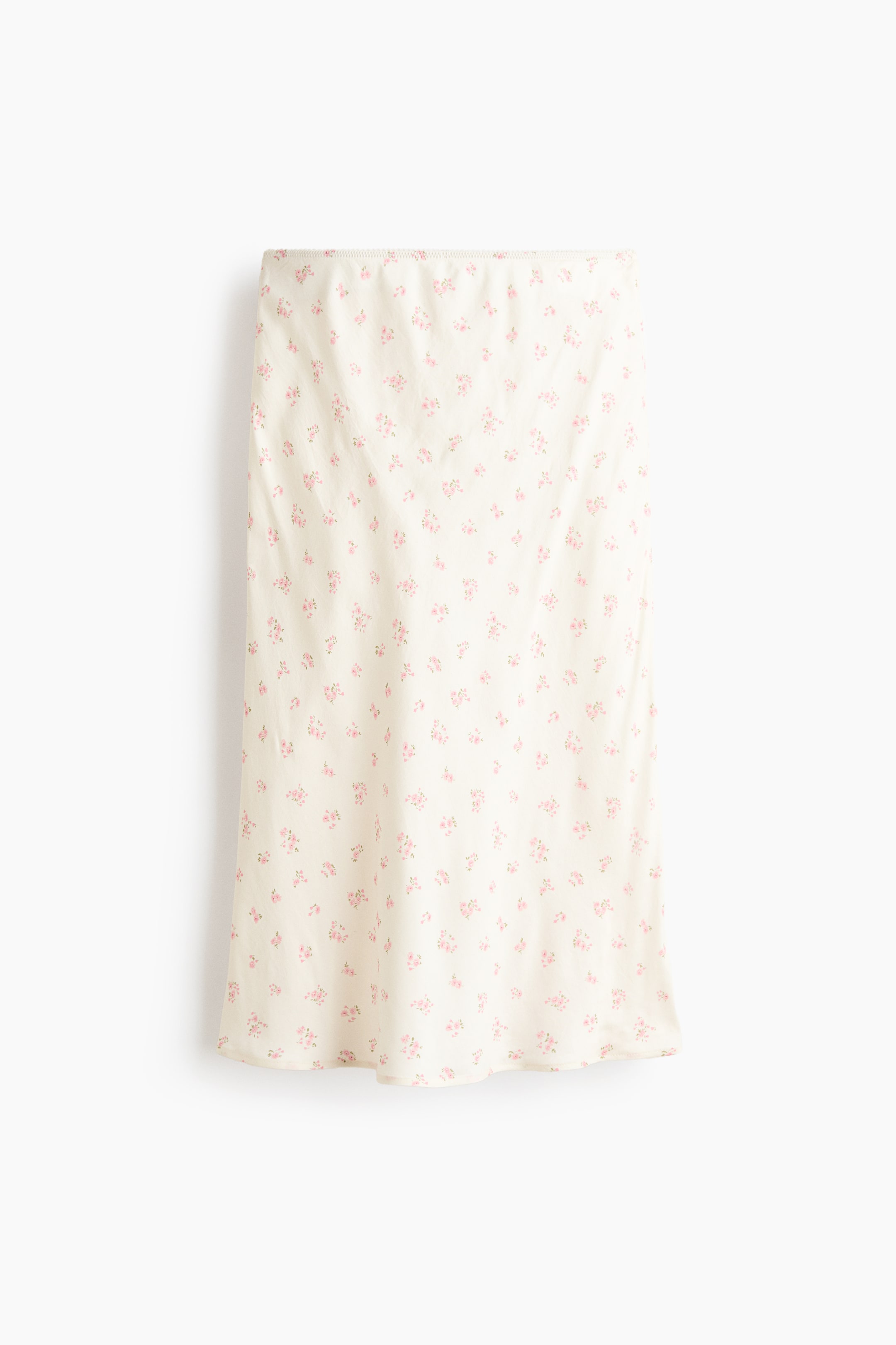 Ver imagen más grande: Una falda muestra un color crema con un estampado floral pequeño en rosa disperso. Está diseñada en un largo midi con un dobladillo recto, y su cintura elástica frontal es visible.