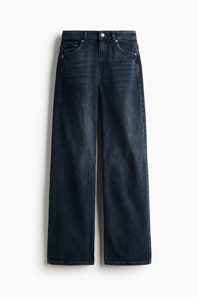 A pair of dark blue, high-waisted denim jeans is shown from the front, featuring a classic five-pocket design with a button closure and zip fly. The jeans have a regular fit from the waist to the hips, then flow into a loose, straight-leg cut. - 1