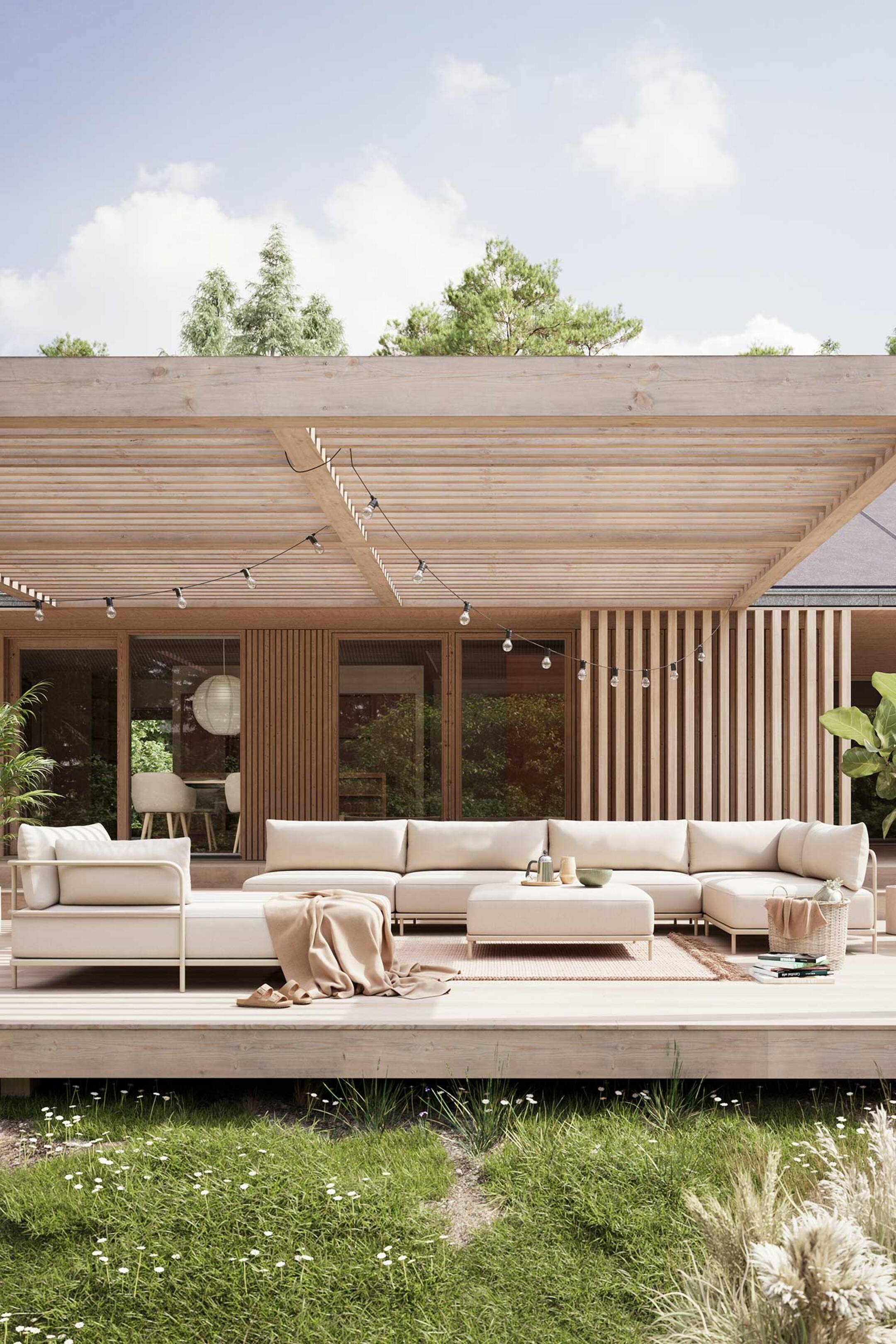 Größeres Bild ansehen: Ein großes, L-förmiges Outdoor-Sofa mit passendem Ottoman wird in einem hellen Beigeton präsentiert, leicht nach rechts geneigt. Das Sofa ist mit dicken Sitz- und Rückenkissen und einem dünnen, hellen Rahmen konstruiert. Eine hellbraune Decke ist über einen Abschnitt drapiert, ein kleines rechteckiges Tablett ruht auf dem Ottoman, und ein geflochtener Korb steht neben dem rechten Ende des Sofas.