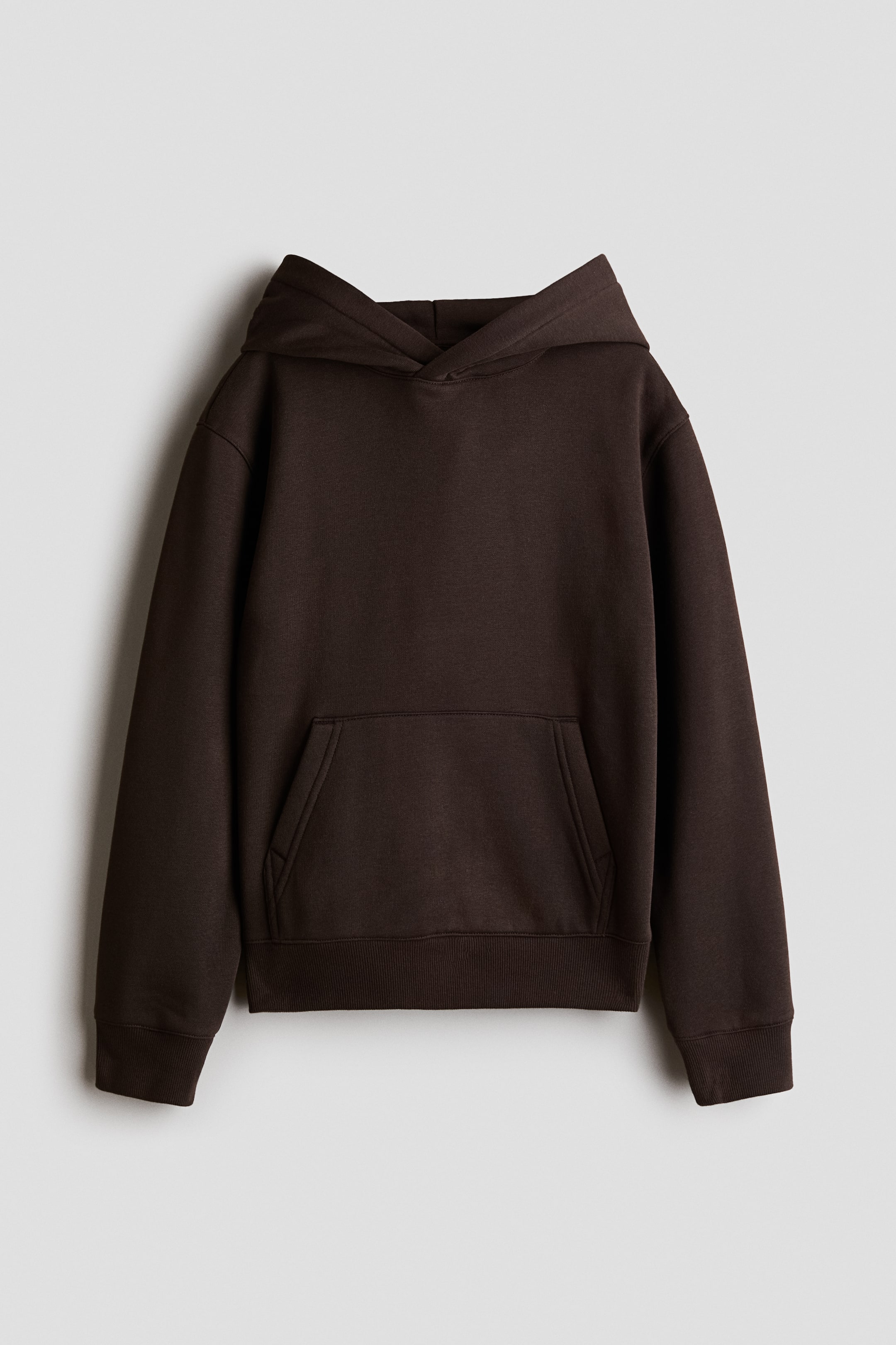 View larger image: A brown hoodie is facing front, crafted from sweatshirt fabric and featuring a hood with a wrapover front, gently dropped shoulders, long sleeves, a kangaroo pocket, and ribbed cuffs and hem.