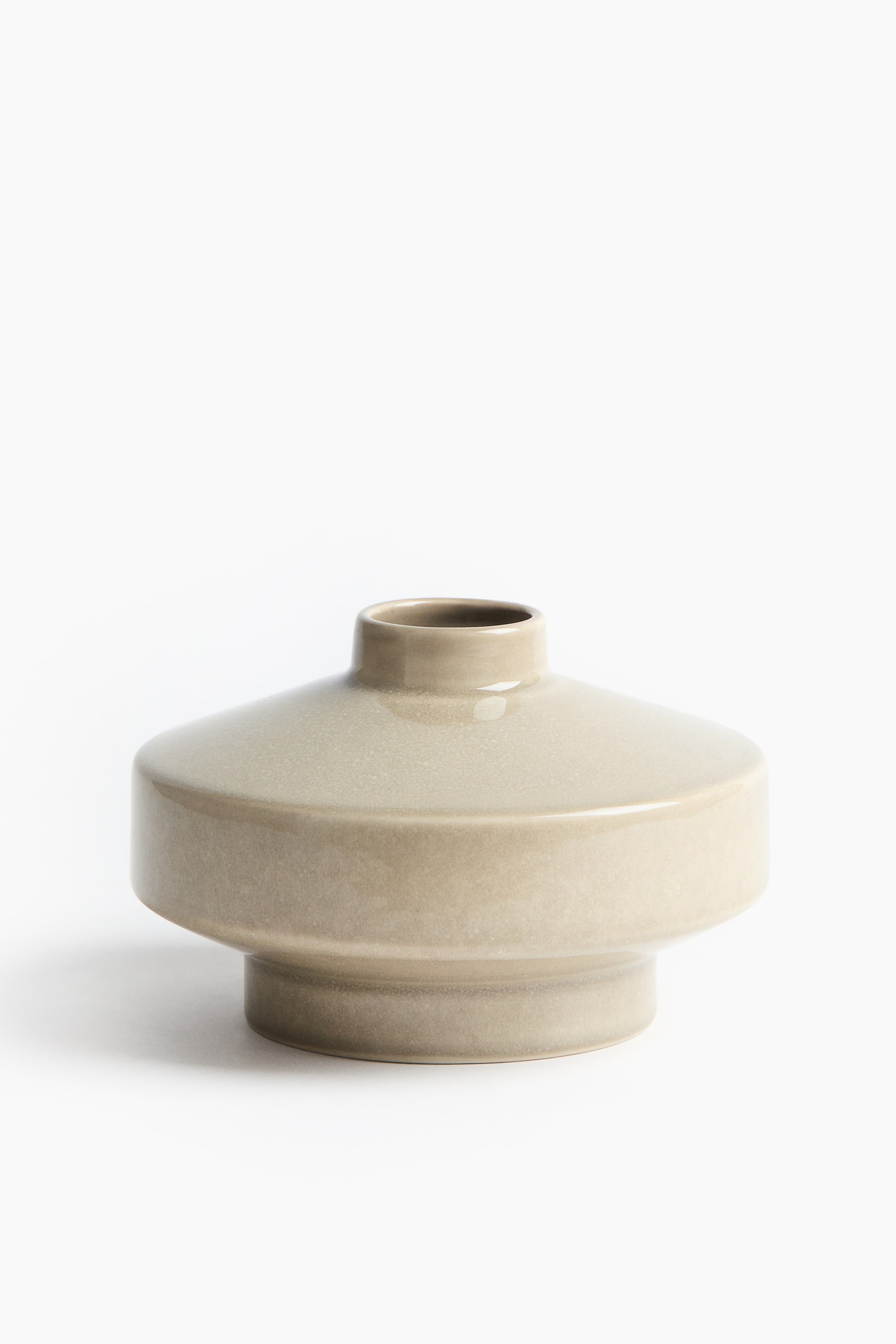 View larger image: A greige ceramic vase is featuring a wide, flat, disc-shaped body, narrowing into a short, cylindrical neck at the top and a narrower, cylindrical base at the bottom.