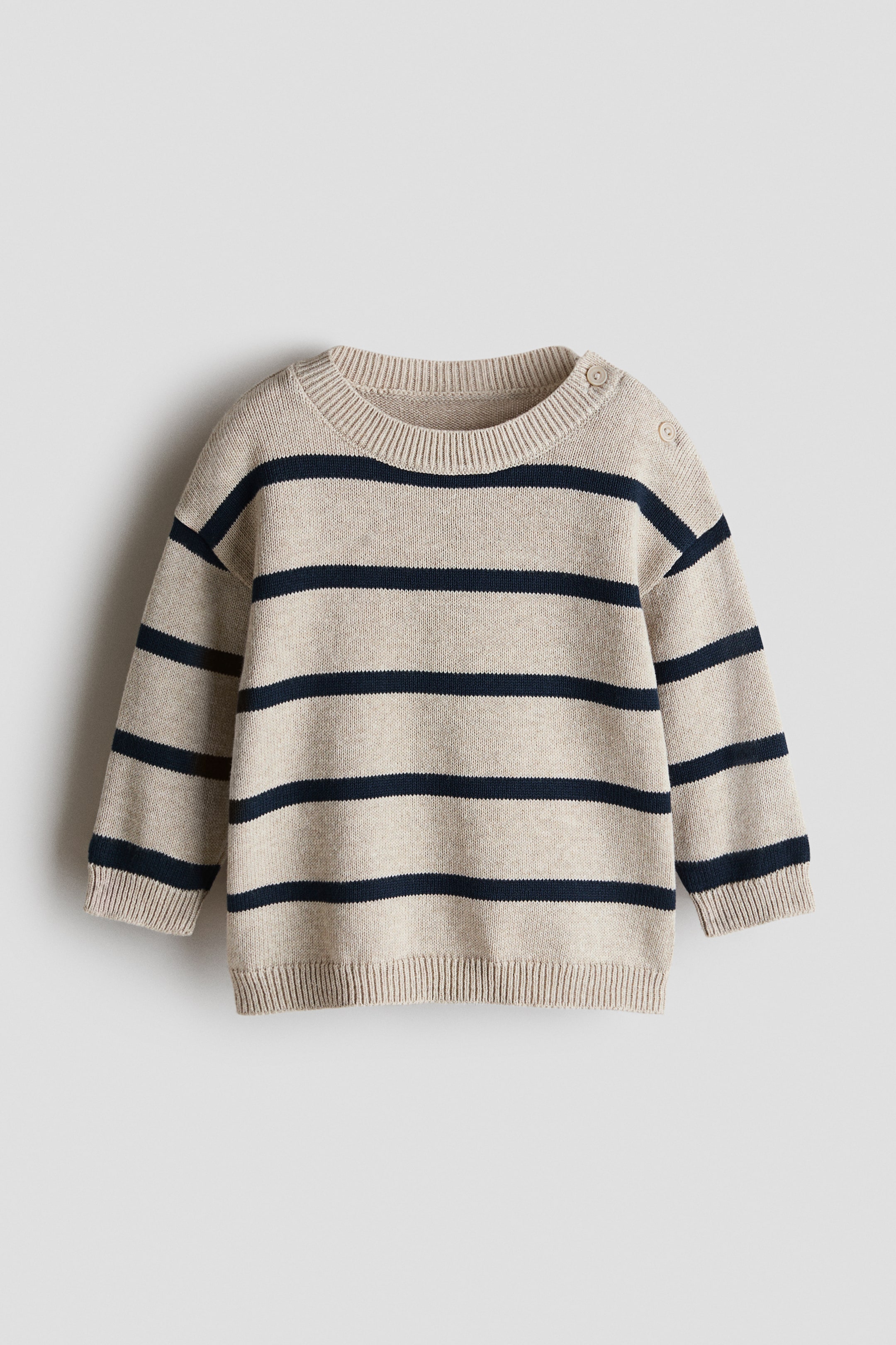View larger image: This jacquard-knit cotton sweater showcases its front with beige and navy horizontal stripes, a round ribbed neckline with buttons on the left shoulder, dropped shoulders, and ribbed cuffs and hem.