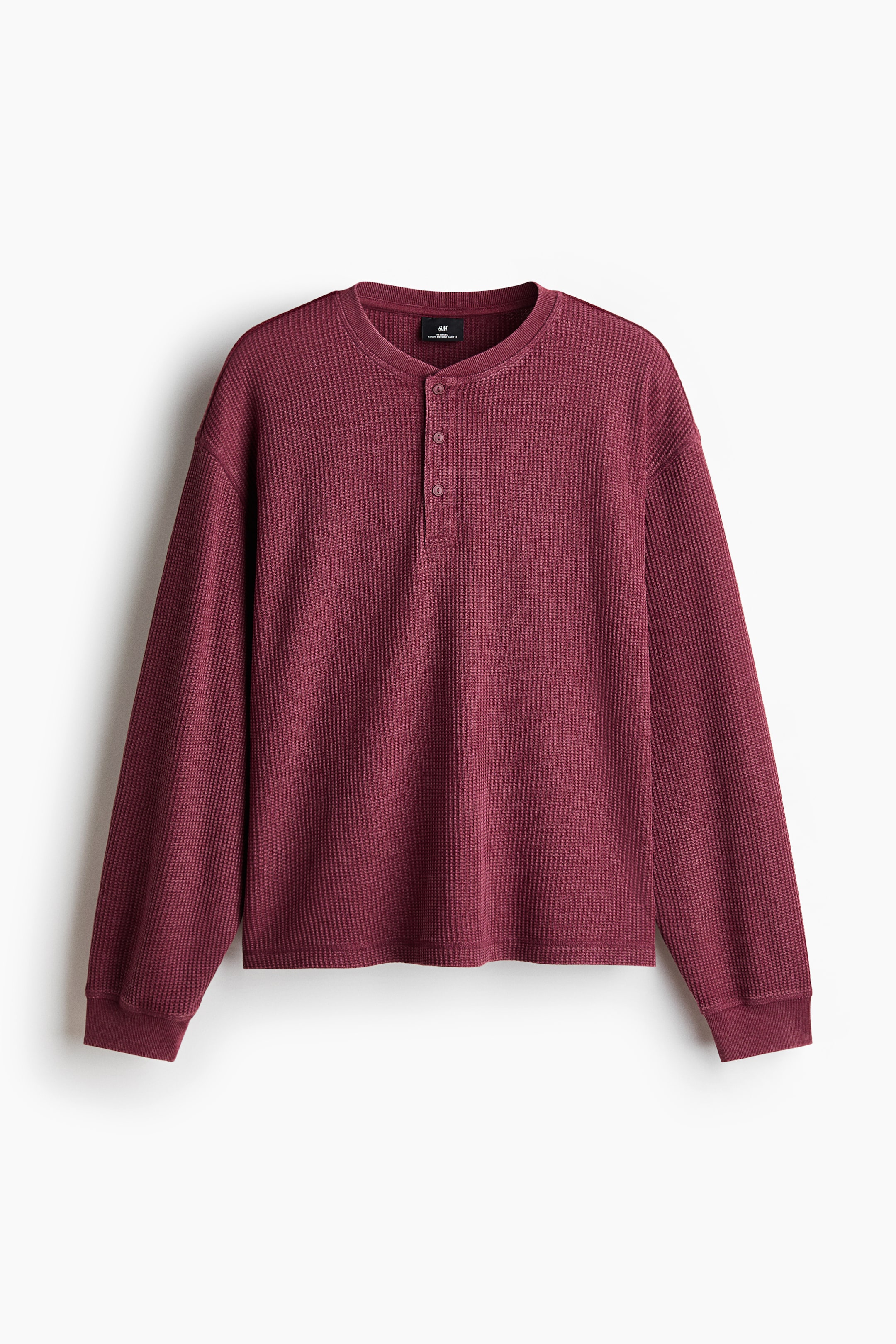 View larger image: A maroon long-sleeved henley shirt showcasing a waffle knit texture, featuring a round neck, a three-button placket, and ribbed cuffs.