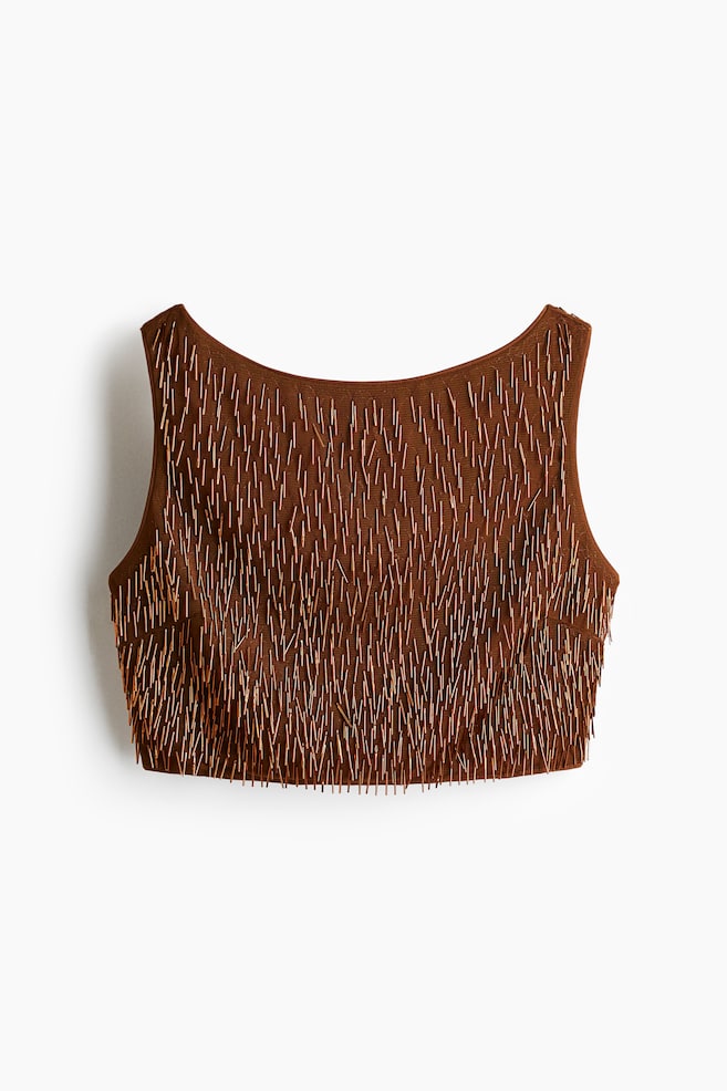 A brown cropped top is being shown from the FRONT. It is sleeveless and features a boat neckline. The top is heavily embellished with numerous thin, metallic-toned bugle beads, creating a textured surface. - 1
