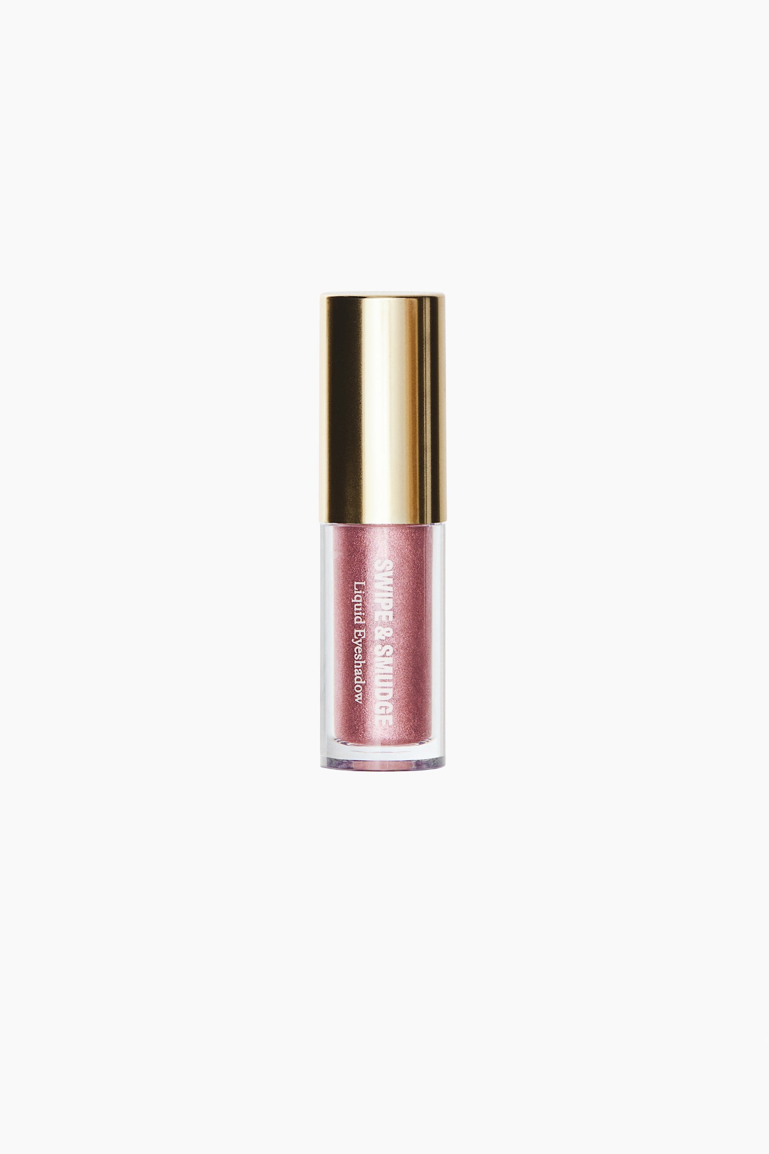 A bottle of liquid eyeshadow is standing upright in a front view, showcasing a clear cylindrical tube filled with a shimmering, metallic rose-pink liquid. The tube is displaying white vertical text that reads "SWIPE & SMUDGE Liquid Eyeshadow" beneath a polished gold cap.