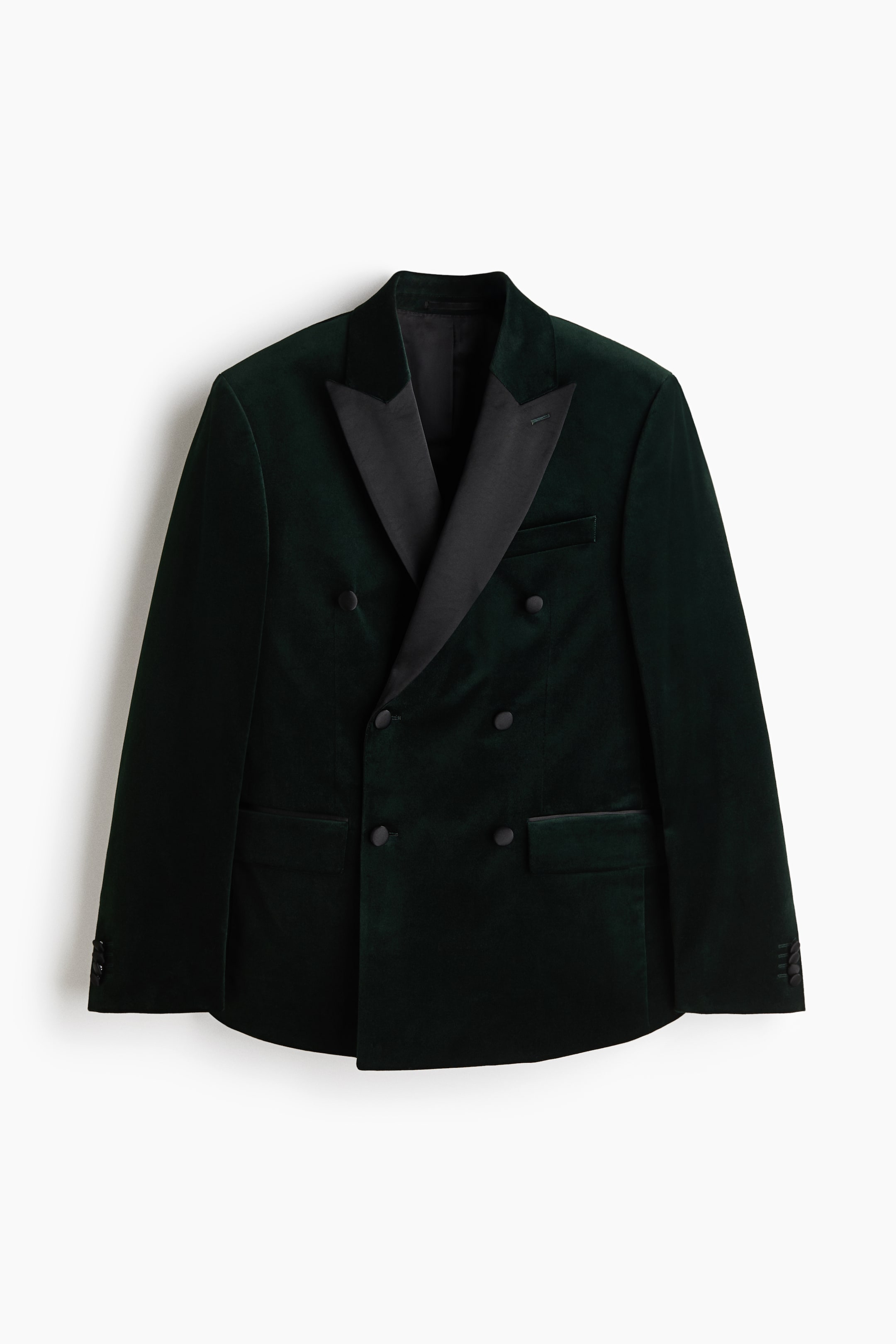 View larger image: A dark green velvet double-breasted blazer is shown front-on, featuring black satin peak lapels, six black buttons, two flap pockets, a jetted chest pocket, and four black buttons on each cuff.