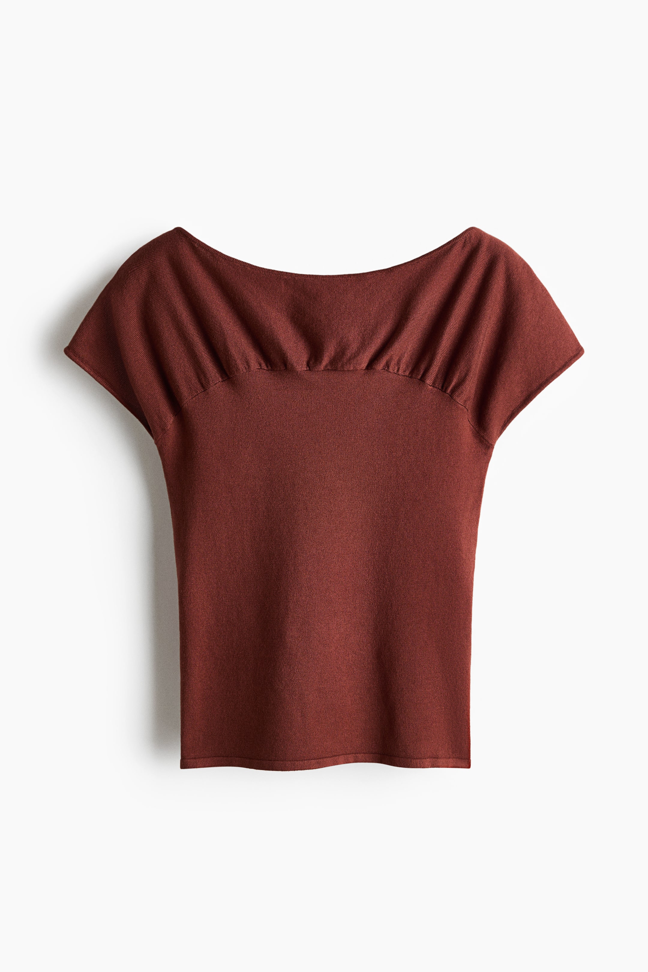 View larger image: The rust-colored top is shown in a front view, featuring a wide boat neckline with prominent gathering across the shoulders and upper bust. It displays short cap sleeves and a fitted body.