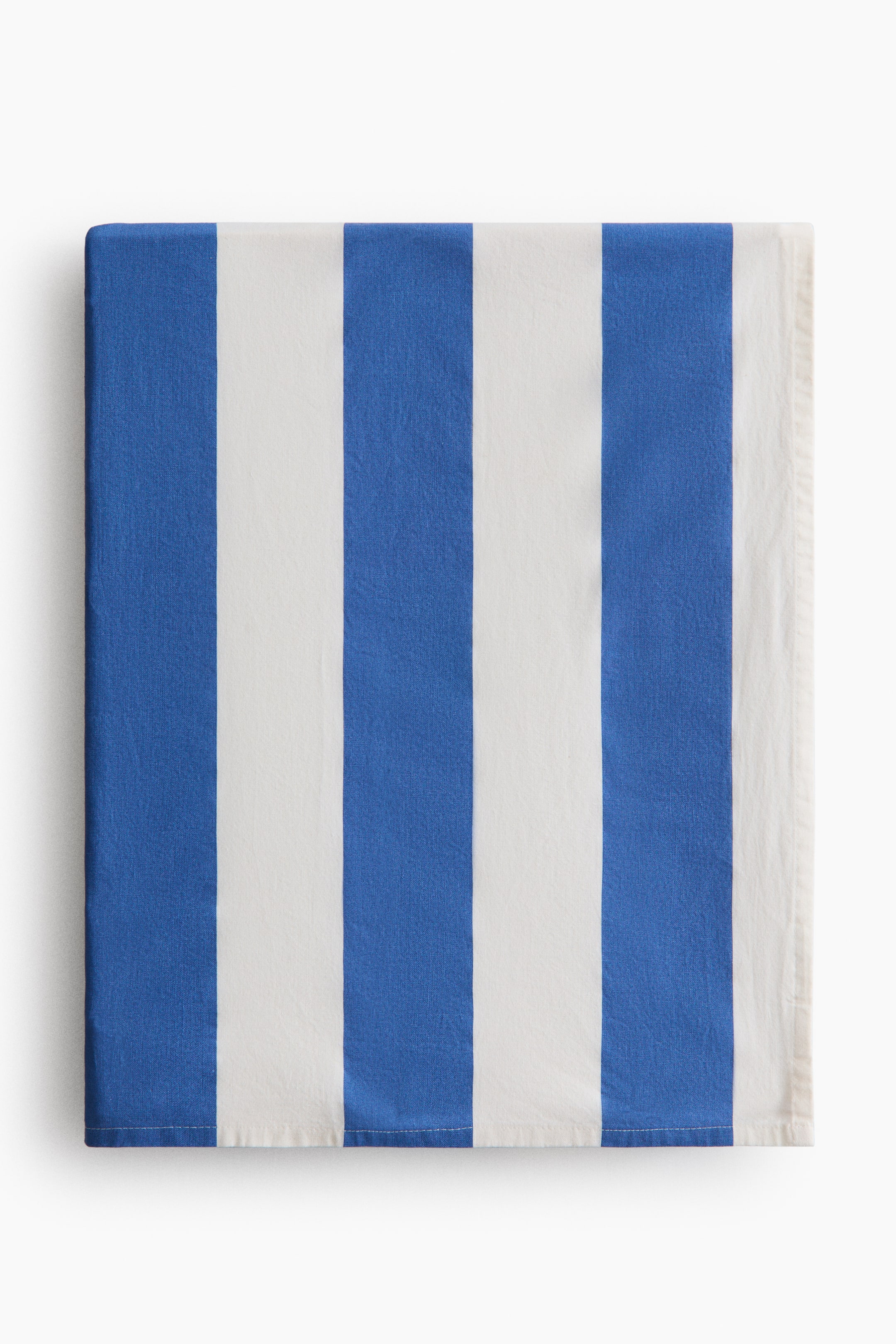 View larger image: A rectangular textile, shown from the front, features alternating vertical blue and white stripes. It appears neatly folded.