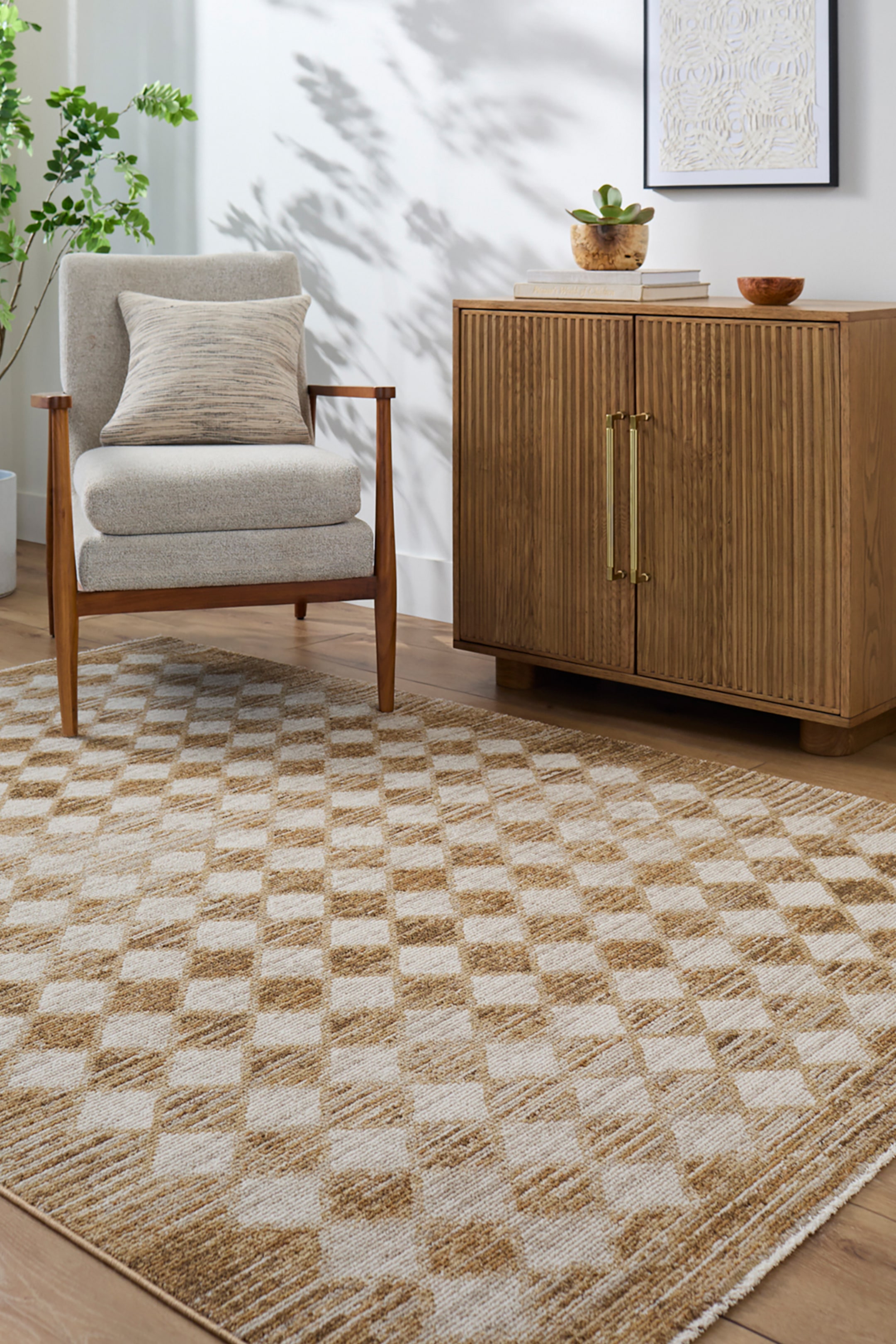 View larger image: A rectangular rug featuring a textured chequerboard pattern with alternating squares in cream and tan hues, lying flat on the floor.