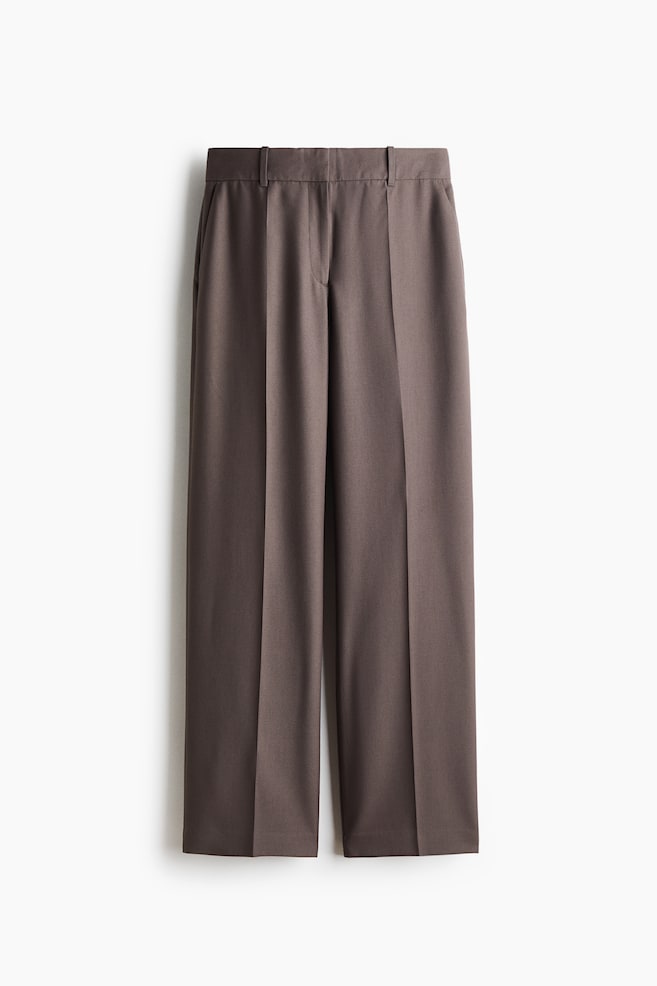Tailored trousers in a taupe wool-blend weave are hanging in a front-facing view, showcasing a straight-leg silhouette with sharp pressed creases running down the front. The trousers feature a structured waistband with belt loops, a concealed front fly, and subtle side pockets. - 1