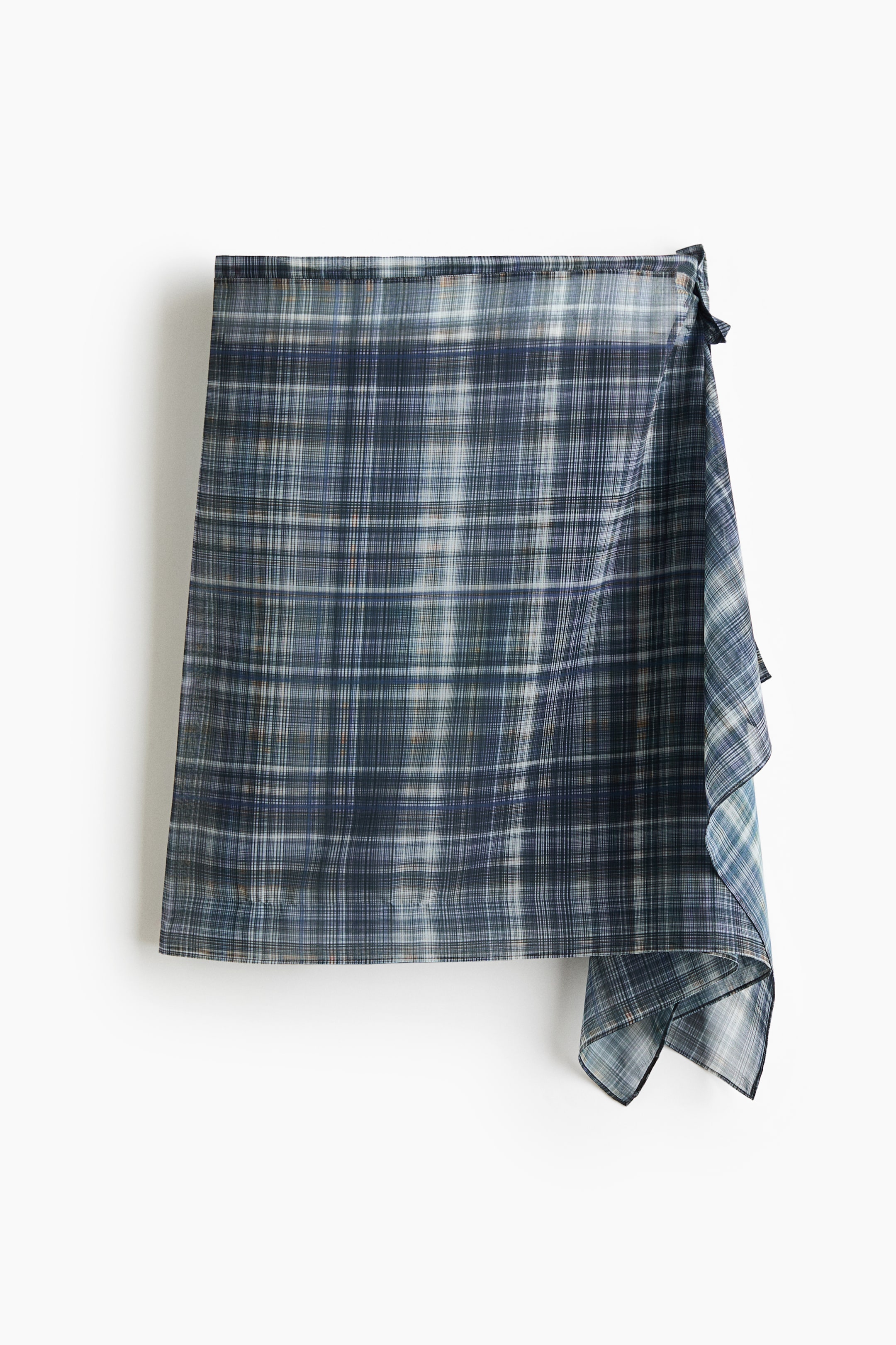 View larger image: A hip scarf in airy chiffon featuring a blue and white check pattern, with draped panels on one side and wide ties above.