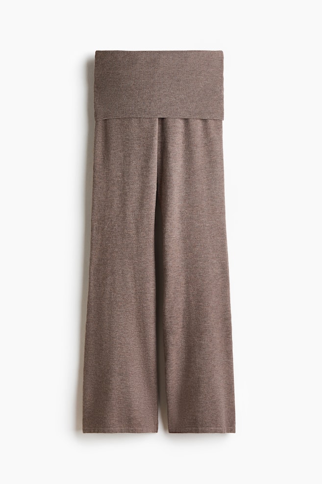 A pair of soft knit pants in a heathered brown shade is shown from the front, featuring a wide, ribbed foldover waistband and relaxed, flared legs. - 1