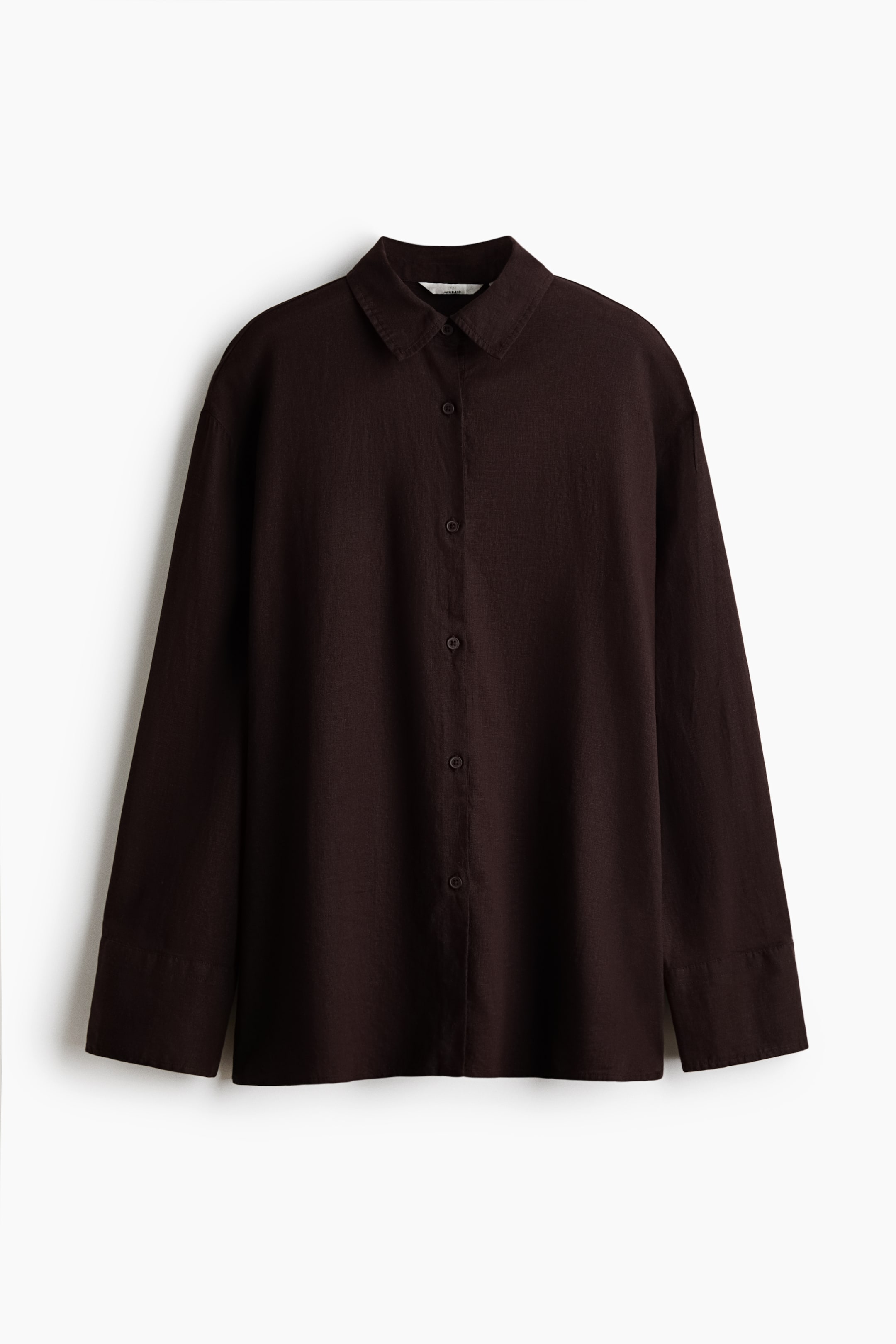 View larger image: A dark brown oversized shirt is facing front, featuring an airy weave, a collar, and buttons down the front. It presents dropped shoulders, long sleeves with buttoned cuffs, and a straight-cut hem with a high slit at each side.