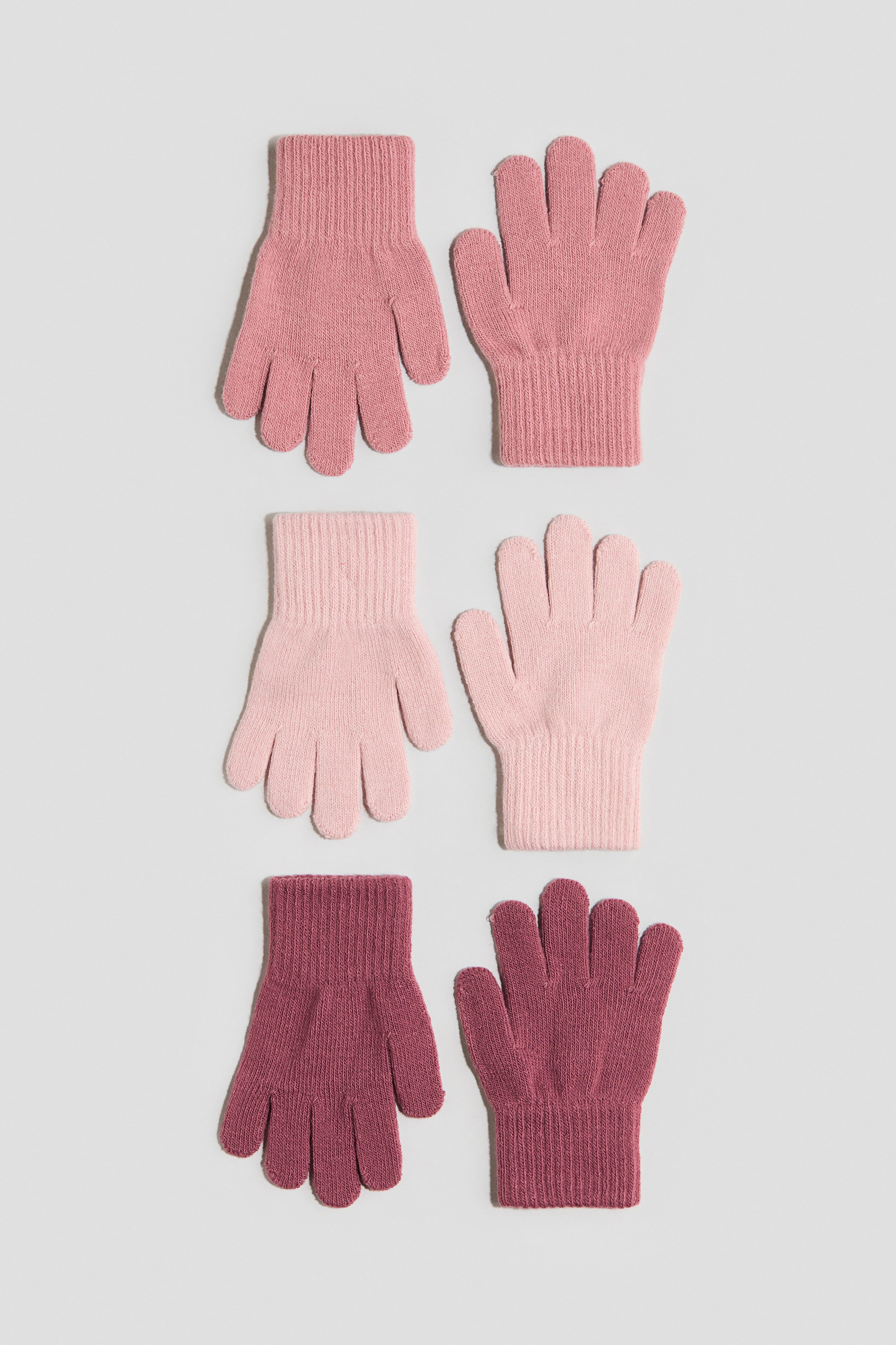 Visualizza immagine più grande: Guanti in morbida maglia fine con polsini a coste vengono presentati in tre paia, ciascuno mostrato in vista frontale. Sono disponibili nelle tonalità rosa chiaro, rosa medio e rosa-rossastro.