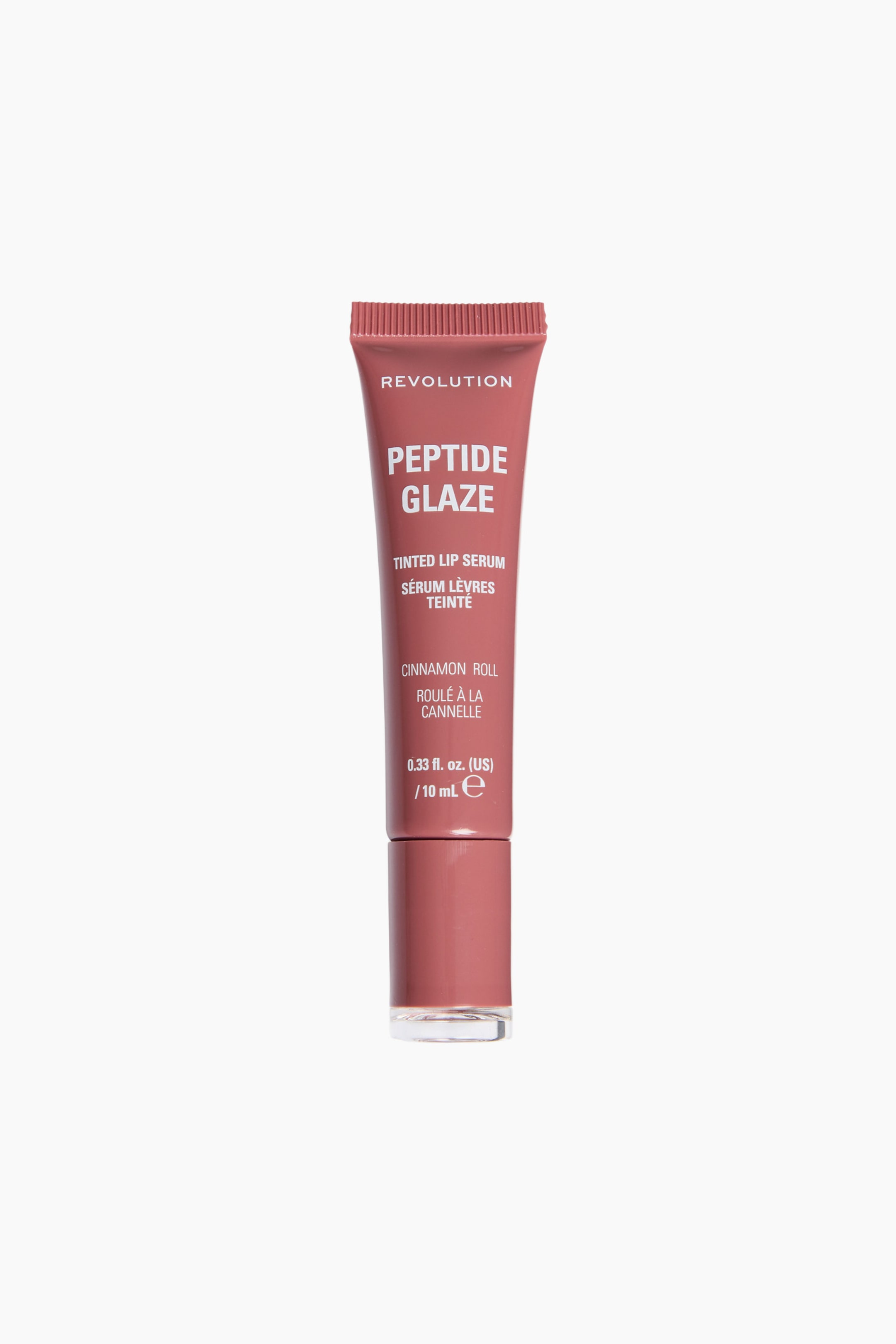 Visa större bild: En tub Revolution Peptide Glaze Tinted Lip Serum står upprätt och vänd rakt framåt, vilket visar upp dess dammrosa förpackning. Plasttuben med klämfunktion har vit tryckt text med varumärke och produktinformation och avslutas med ett matchande cylindriskt lock med en genomskinlig, platt botten.