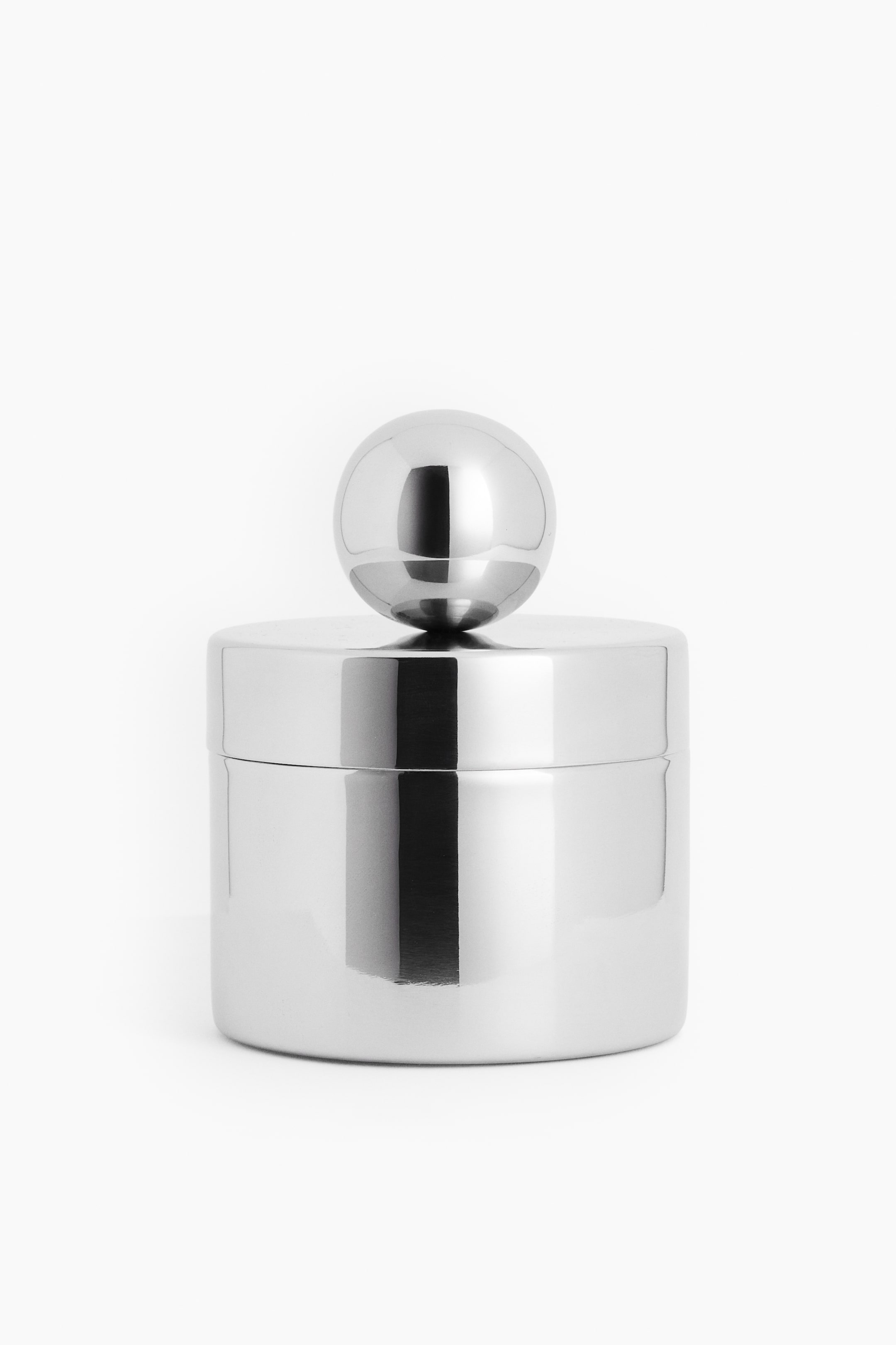 View larger image: A polished silver metal container is featuring a short cylindrical body with a flat lid, topped by a spherical handle, facing front.