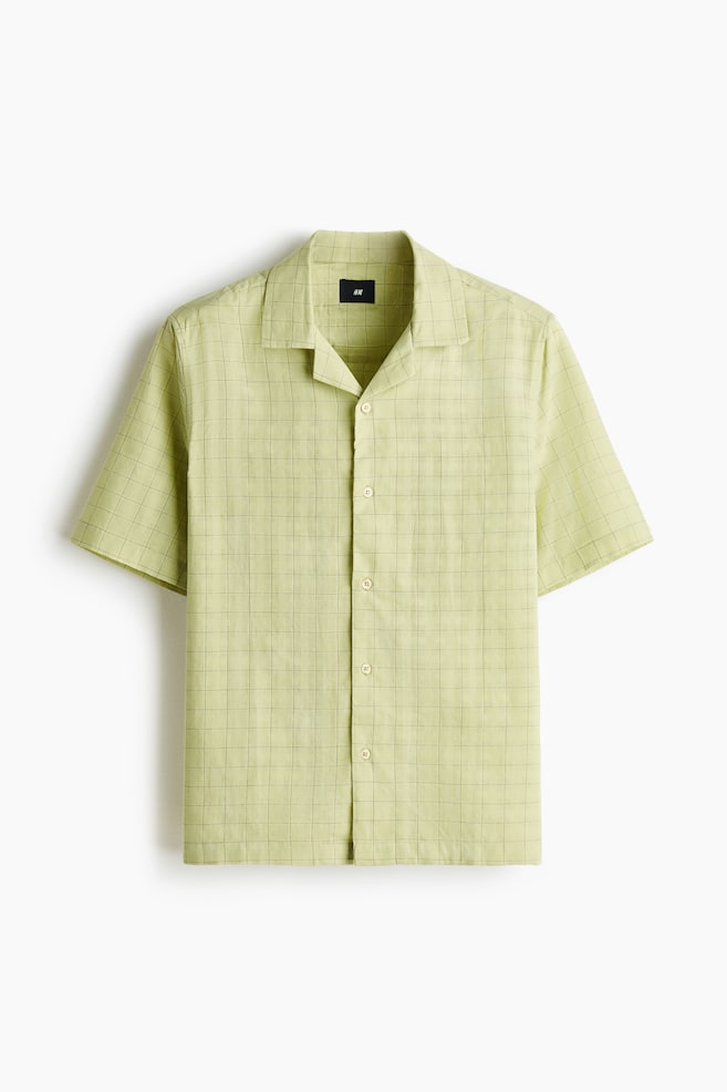 A light green short-sleeved shirt is shown from the front. It features a subtle grid pattern, a revere collar, a full button-front closure and a single patch pocket on the left chest. - 1