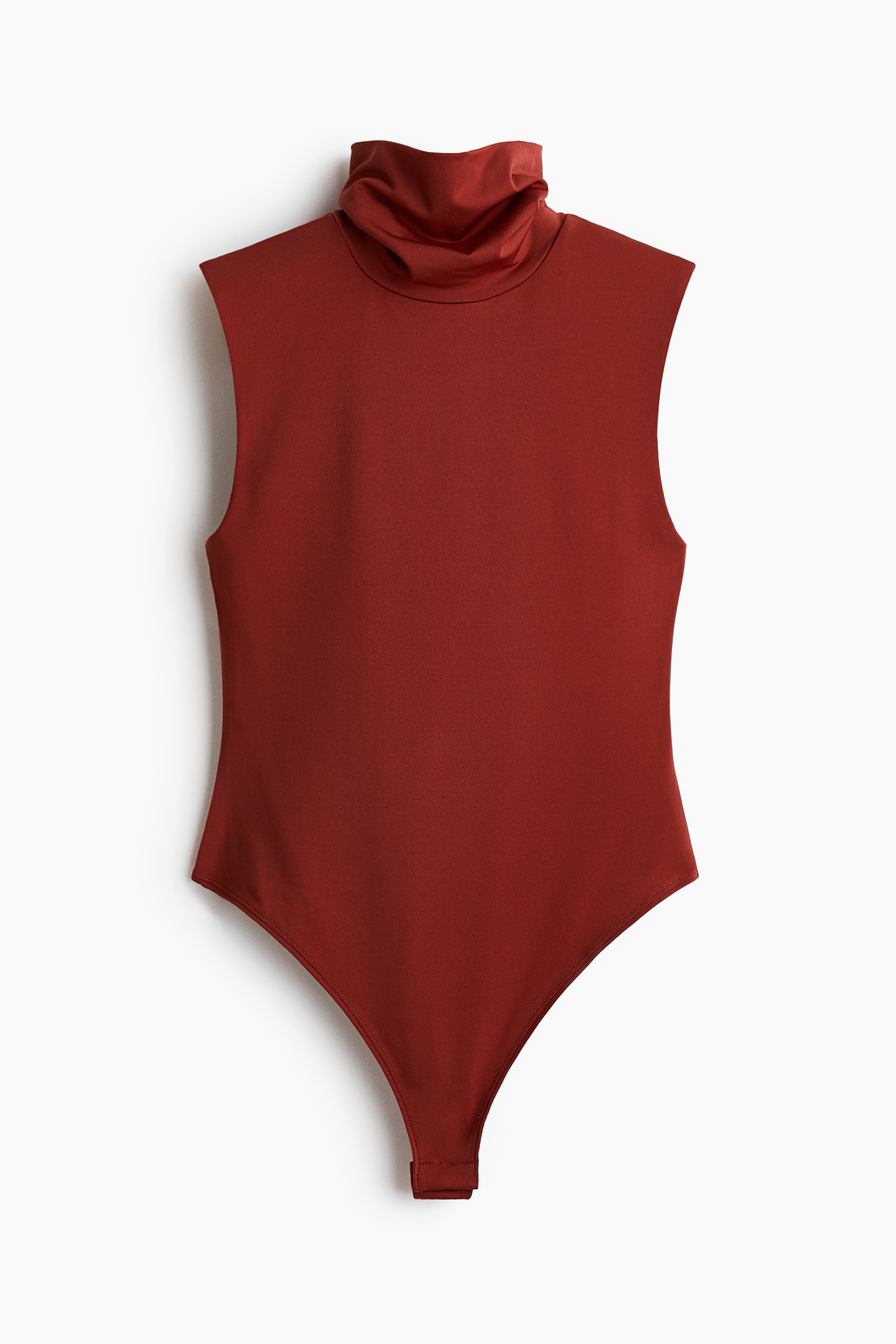 A rust-coloured sleeveless turtleneck top is worn by the model, shown in side profile. The top features a high, slightly draped neckline and a form-fitting silhouette.