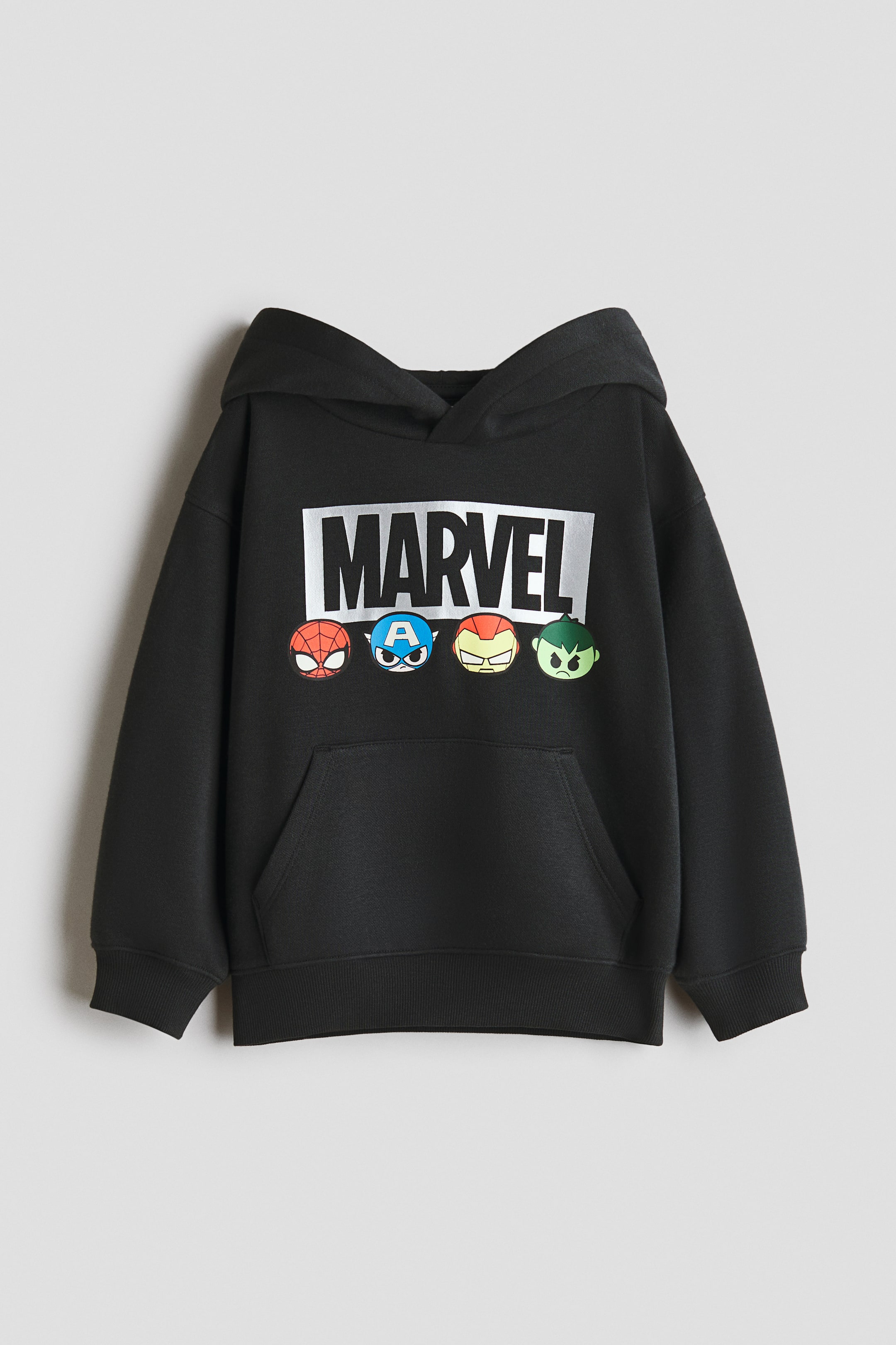 View larger image: A black hoodie is shown from the front, featuring a large silver "MARVEL" logo positioned above four stylized superhero character faces. It is designed with a hood, a front kangaroo pocket, and ribbed cuffs and hem.