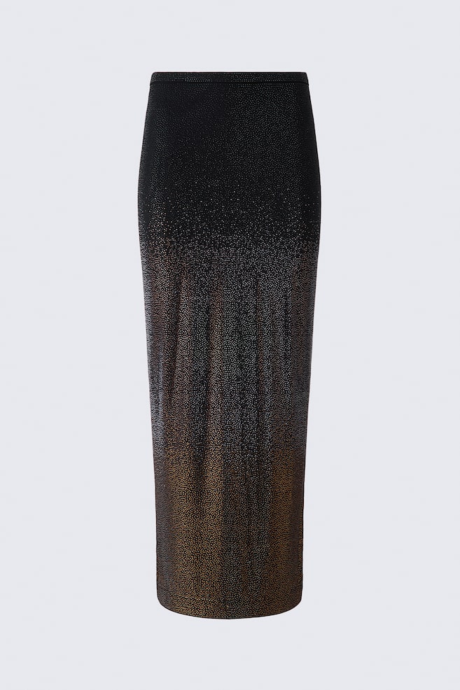 A calf-length black jersey skirt is shown from the front, featuring a straight silhouette and a narrow waistband. The skirt is covered in small, shimmering rhinestones transitioning in a tonal gradient from silver at the top to a golden-bronze hue at the hem. - 1