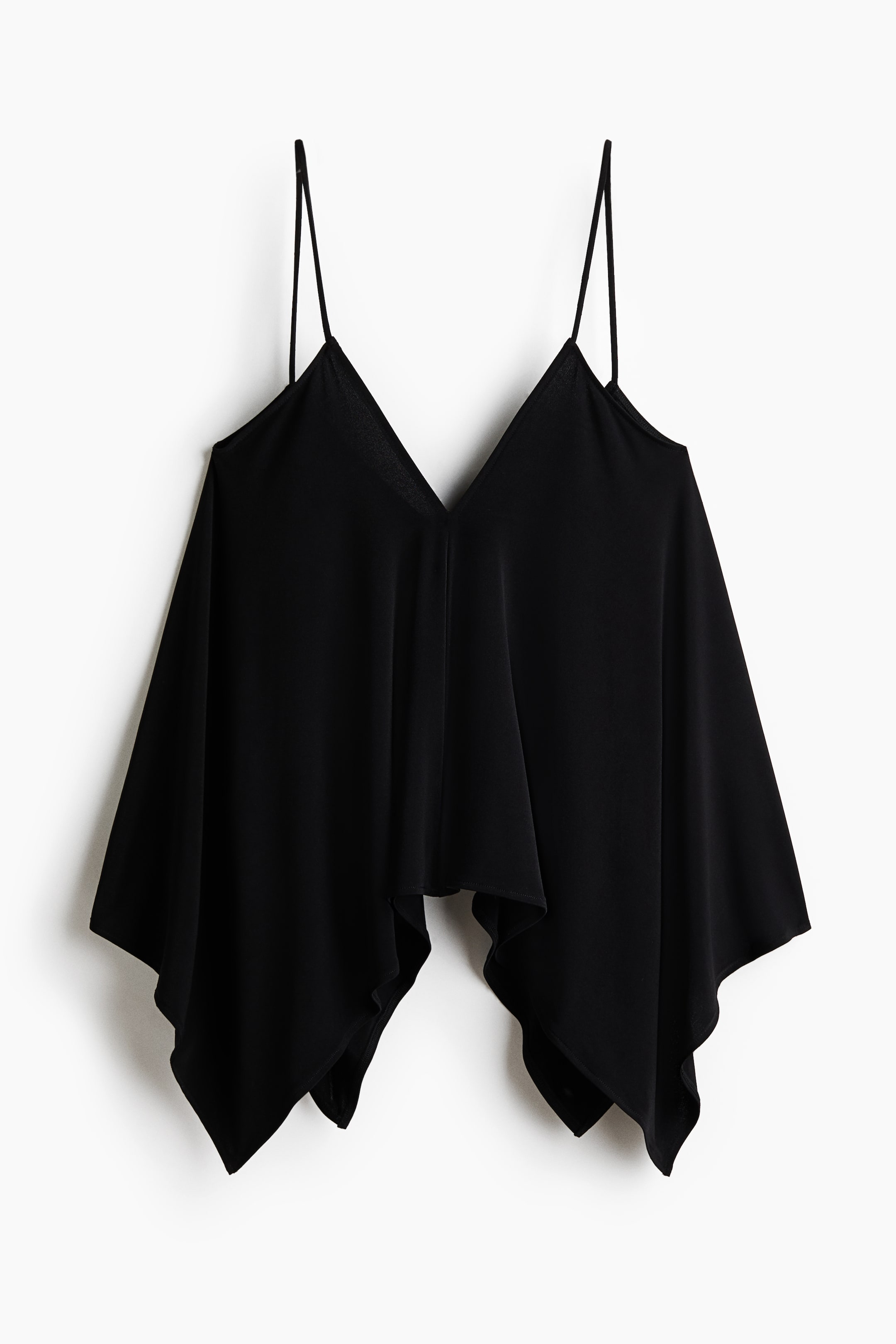 View larger image: A black camisole is displaying its front, featuring thin spaghetti straps and a V-neckline. The garment is showcasing a loose, draped fit with an asymmetrical handkerchief hem, forming pointed edges.