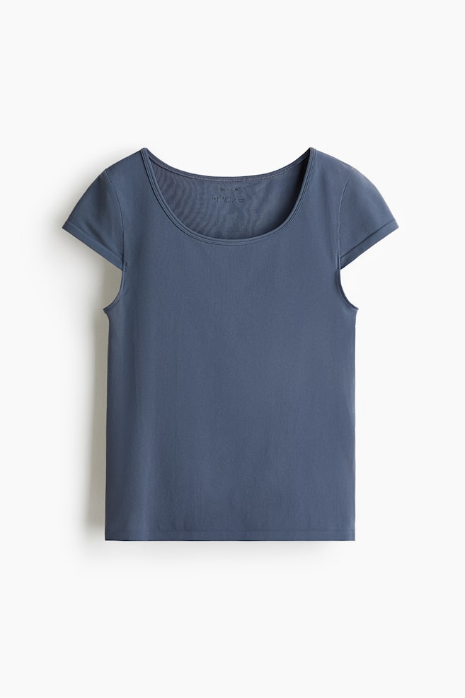 A slate blue t-shirt is lying flat, presenting its front view, featuring a wide, rounded scoop neckline and short cap sleeves. A small printed label is visible inside the neckline, and a straight hem is finishing the bottom edge. - 1