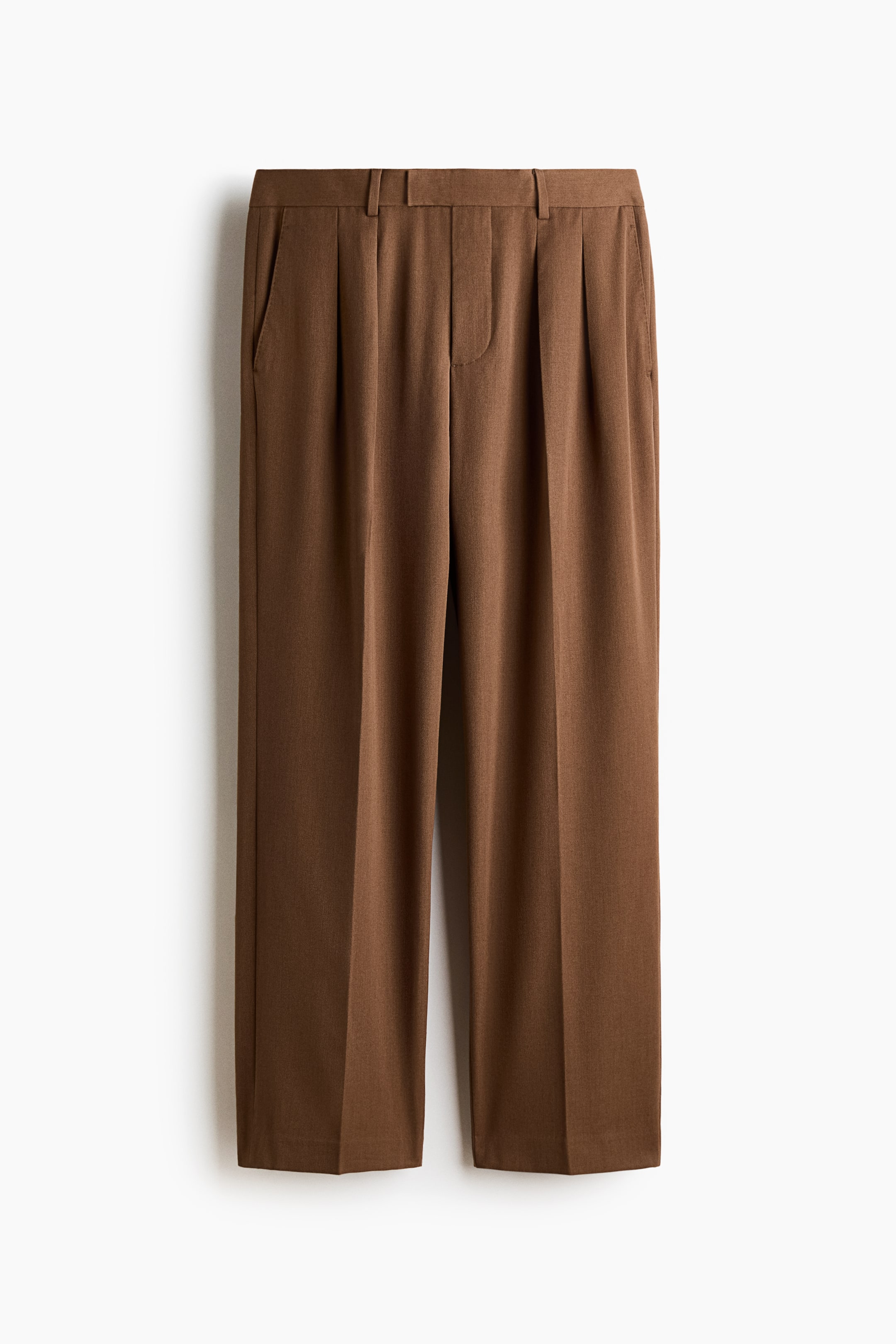 View larger image: Brown trousers are shown from the front, featuring a flat waistband with belt loops, a zipper fly, and two single pleats on each side. Slanted side pockets are visible, and the straight legs have a central crease down to a plain hem.