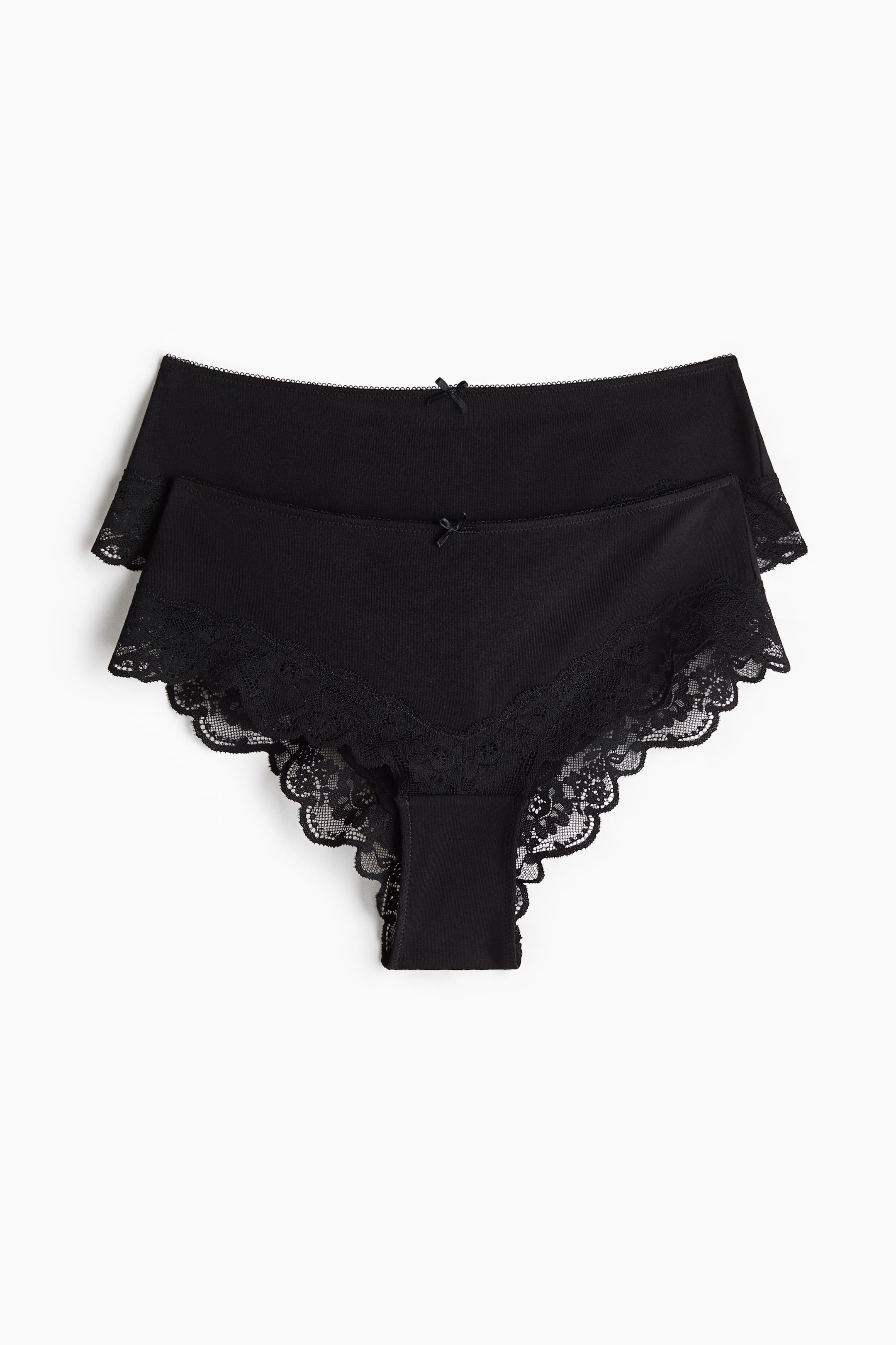 View larger image: Two black panties are shown in a front view, with one pair slightly overlapping the other. Each panty features a small bow at the centre front waistband and is trimmed with delicate scalloped lace along the leg openings.