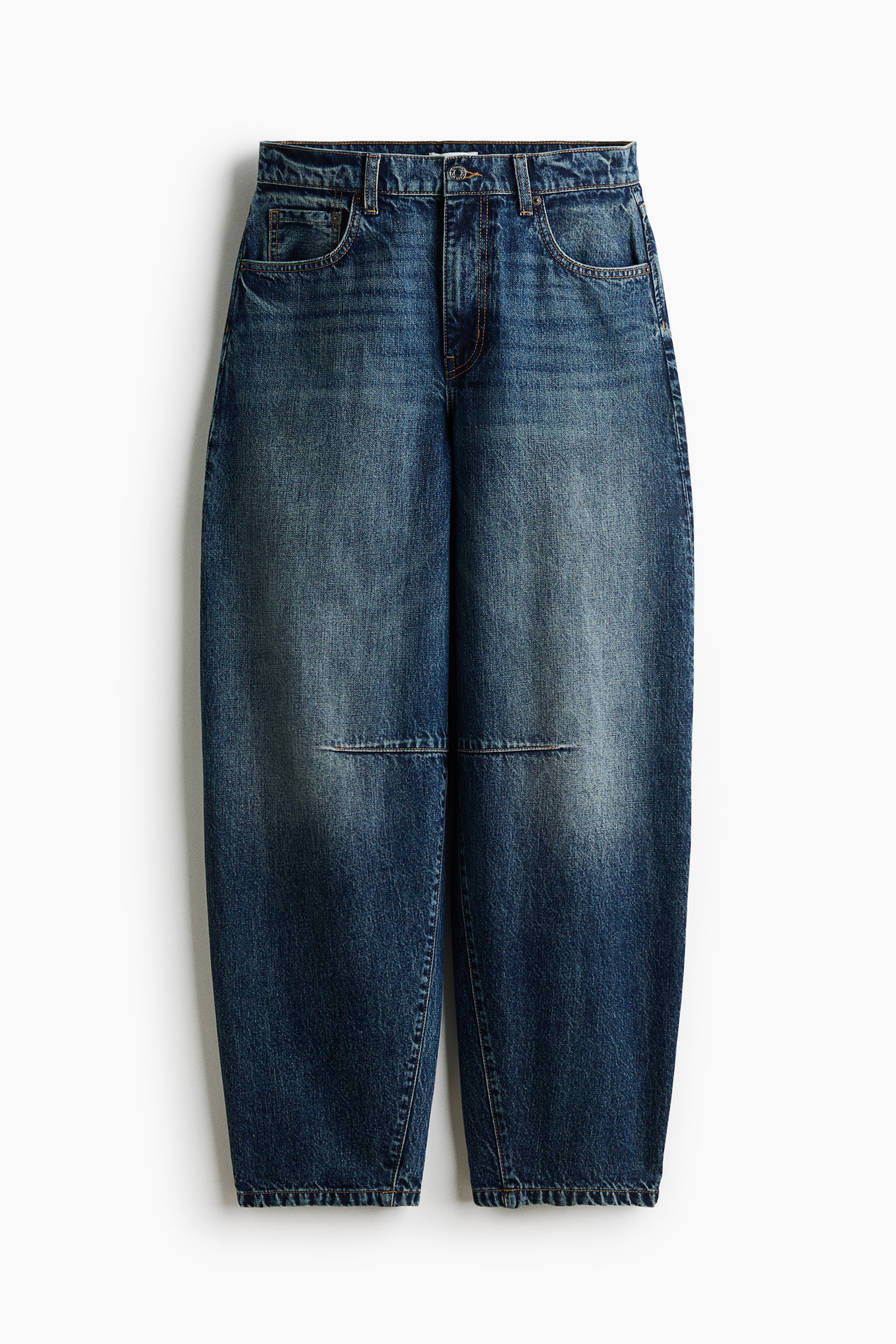 View larger image: These blue barrel-leg jeans are shown from the front, featuring a high-rise waist with belt loops and classic five-pocket styling. They feature a curved, tapered silhouette with a faded wash down the centre of the legs and distinct horizontal seam details at the knees.