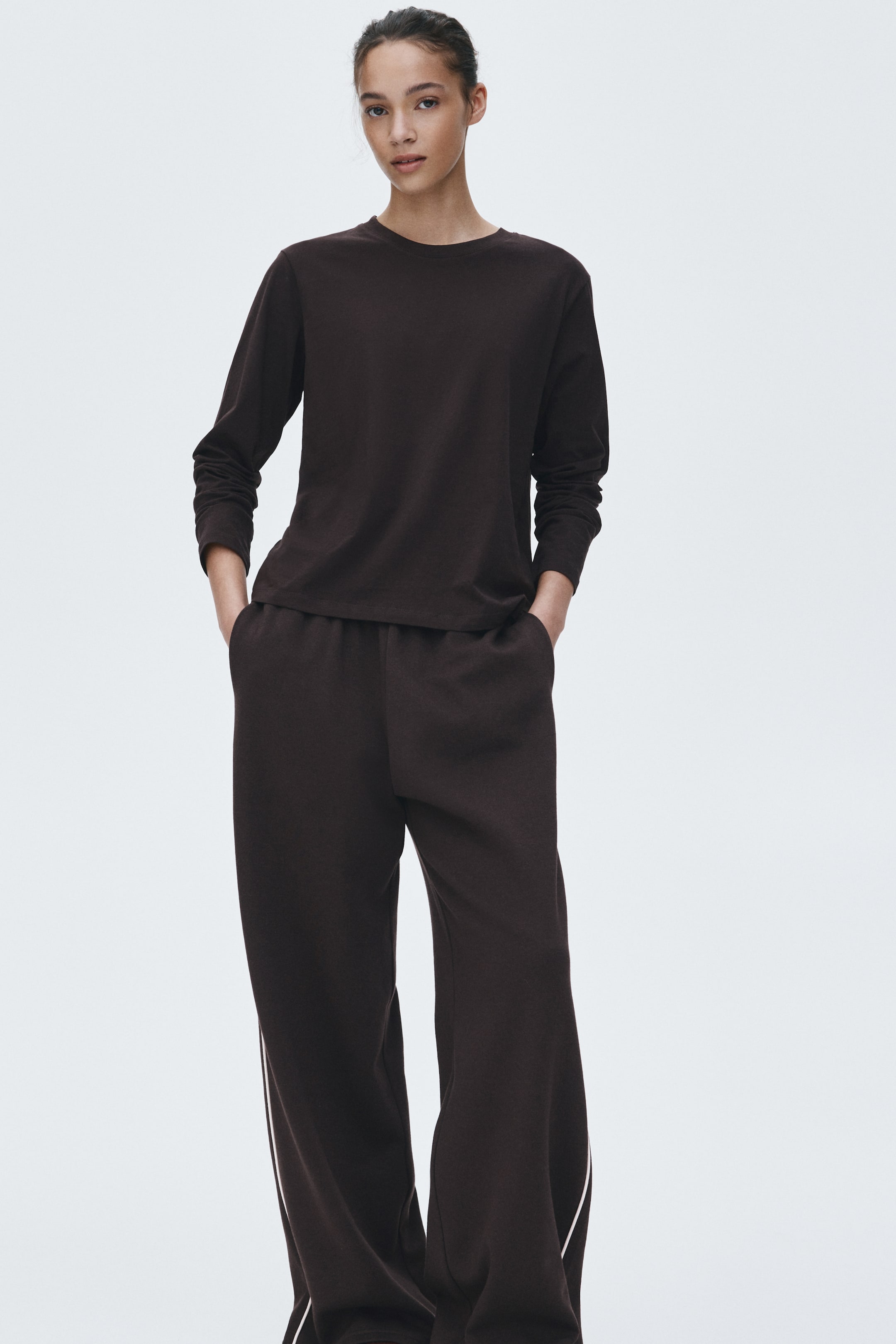 View larger image: A dark brown long-sleeved t-shirt and matching wide-leg pants are forming a coordinated set, facing forward. 