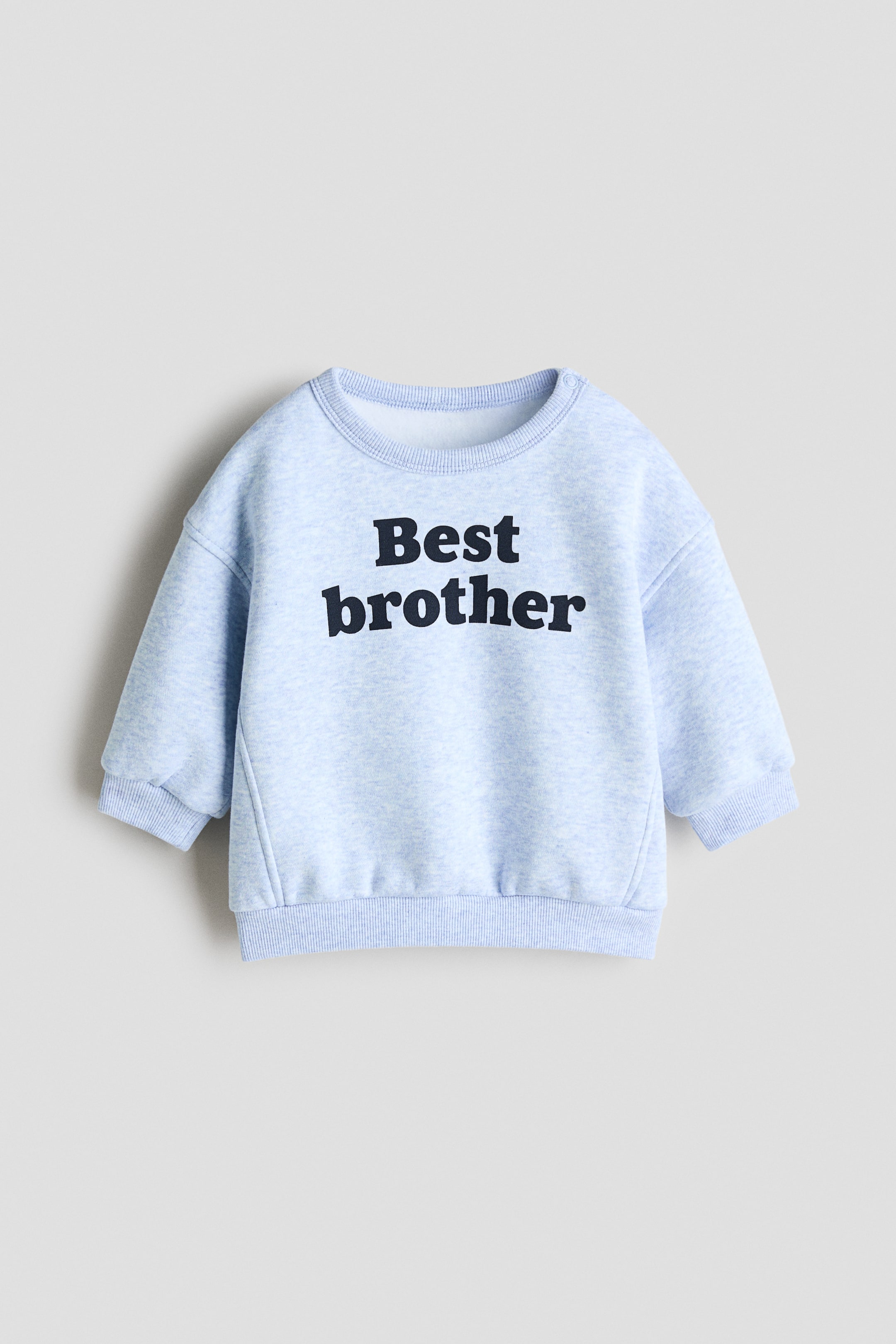 View larger image: A light blue marled sweatshirt is presenting its front, featuring the black text "Best brother" across the chest. It is displaying a crew neck, long sleeves, and ribbed cuffs and hem.